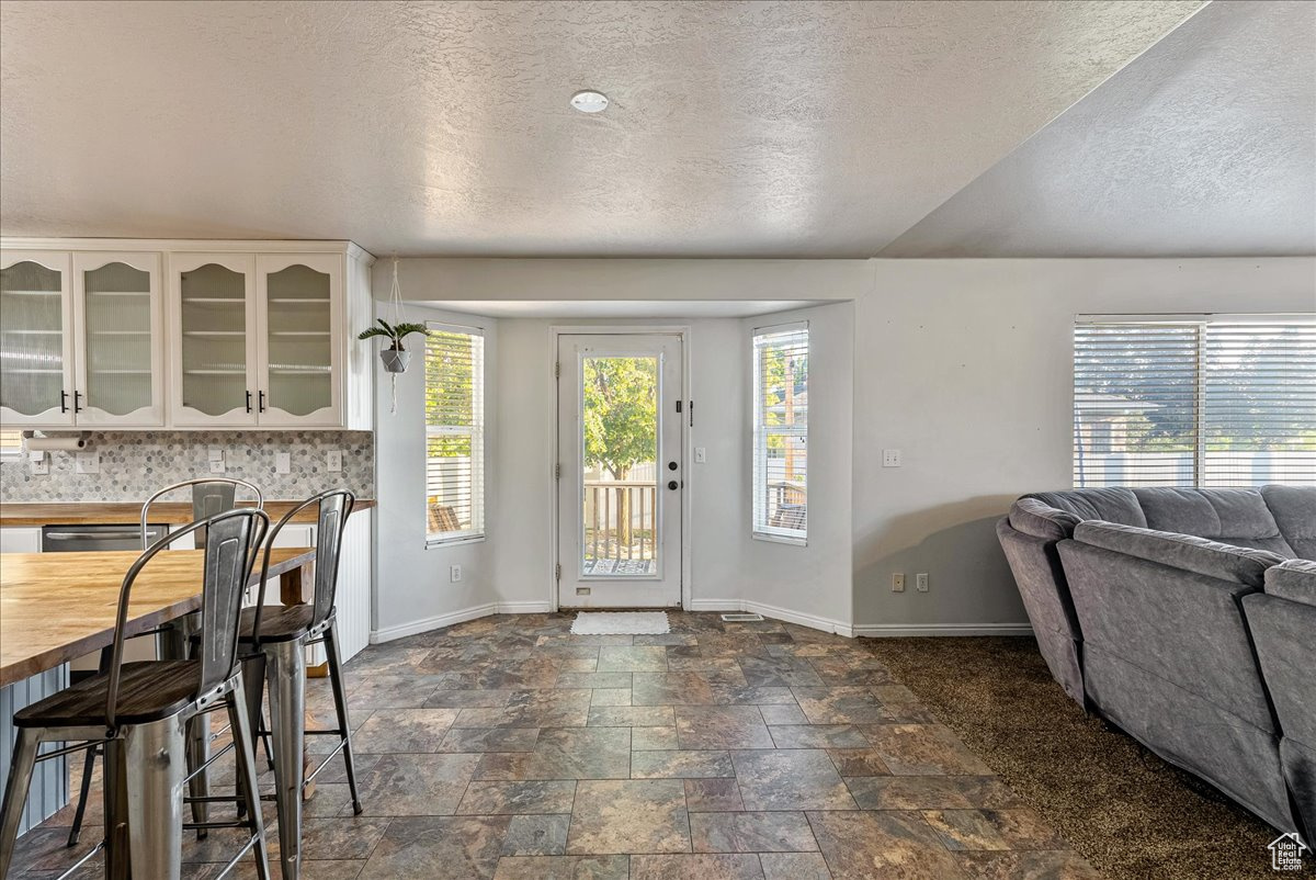 Tiled dining area featuring a textured ceiling