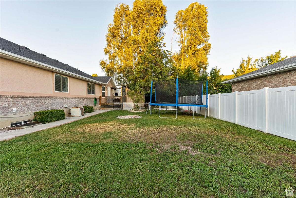 View of yard featuring a trampoline