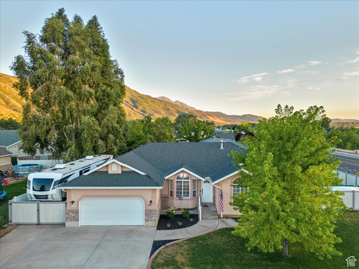 Single-story home with a garage, RV pad, and a mountain view