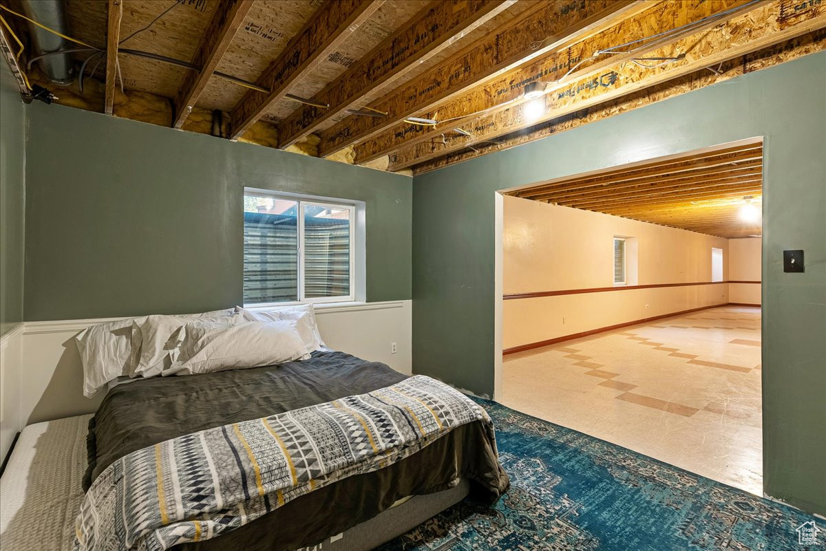 Tiled bedroom with wooden ceiling