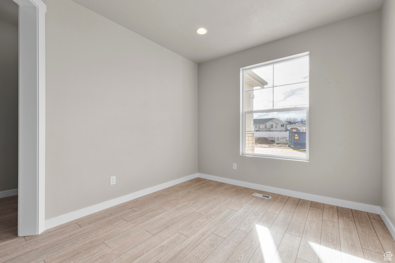 Spare room featuring light wood-type flooring