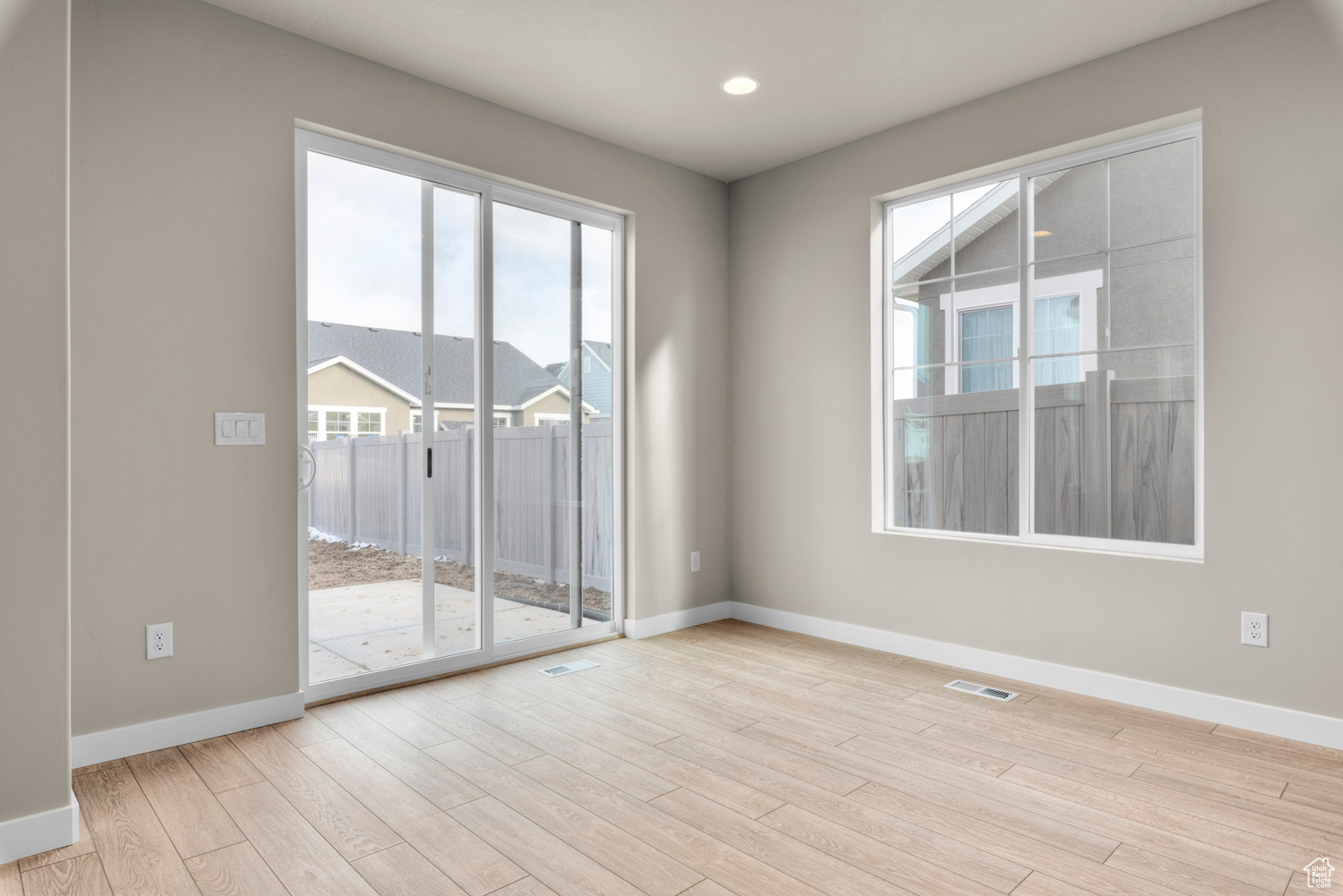 Empty room featuring a wealth of natural light and light hardwood / wood-style flooring