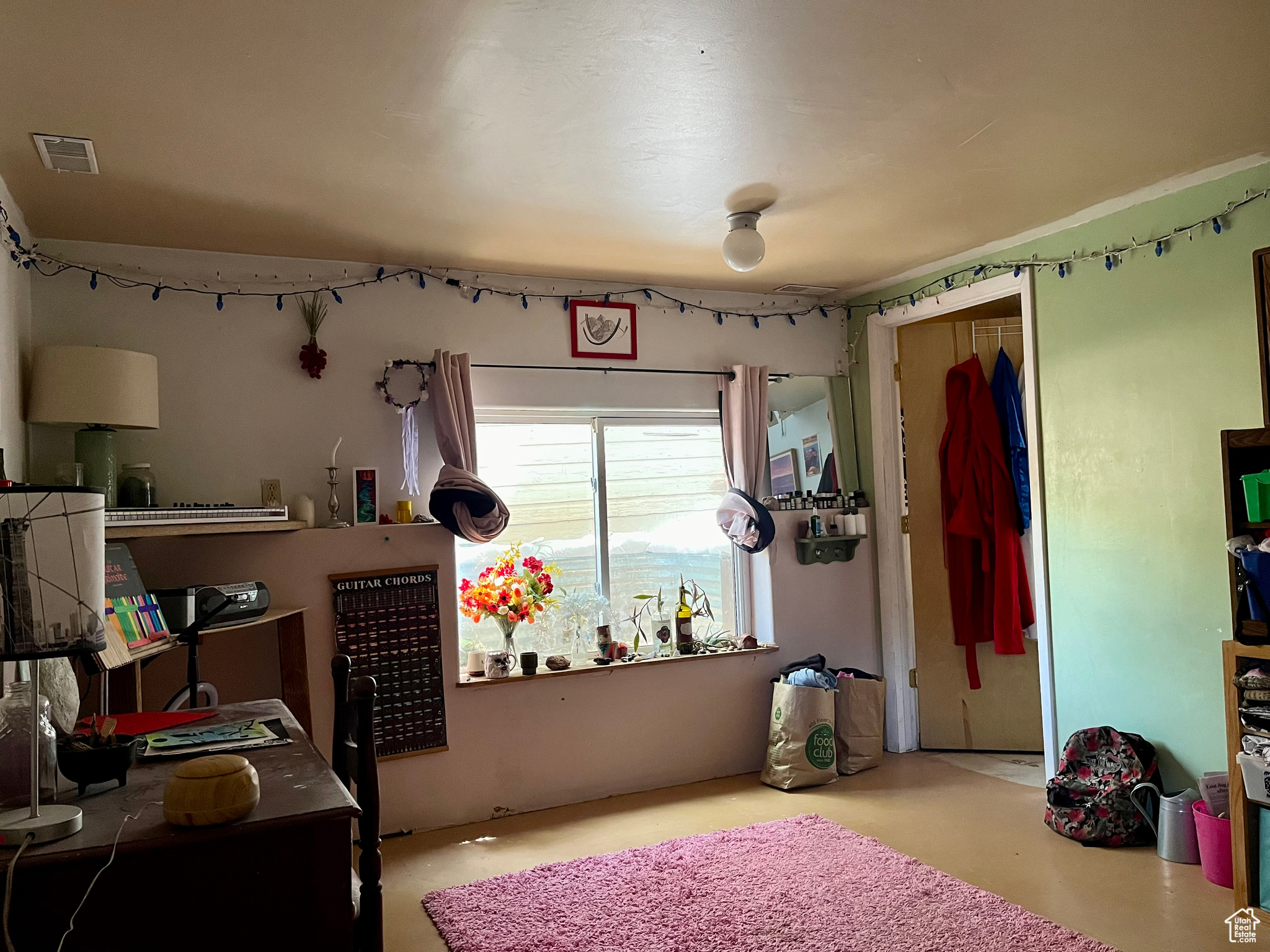 Bedroom with concrete floors and a closet