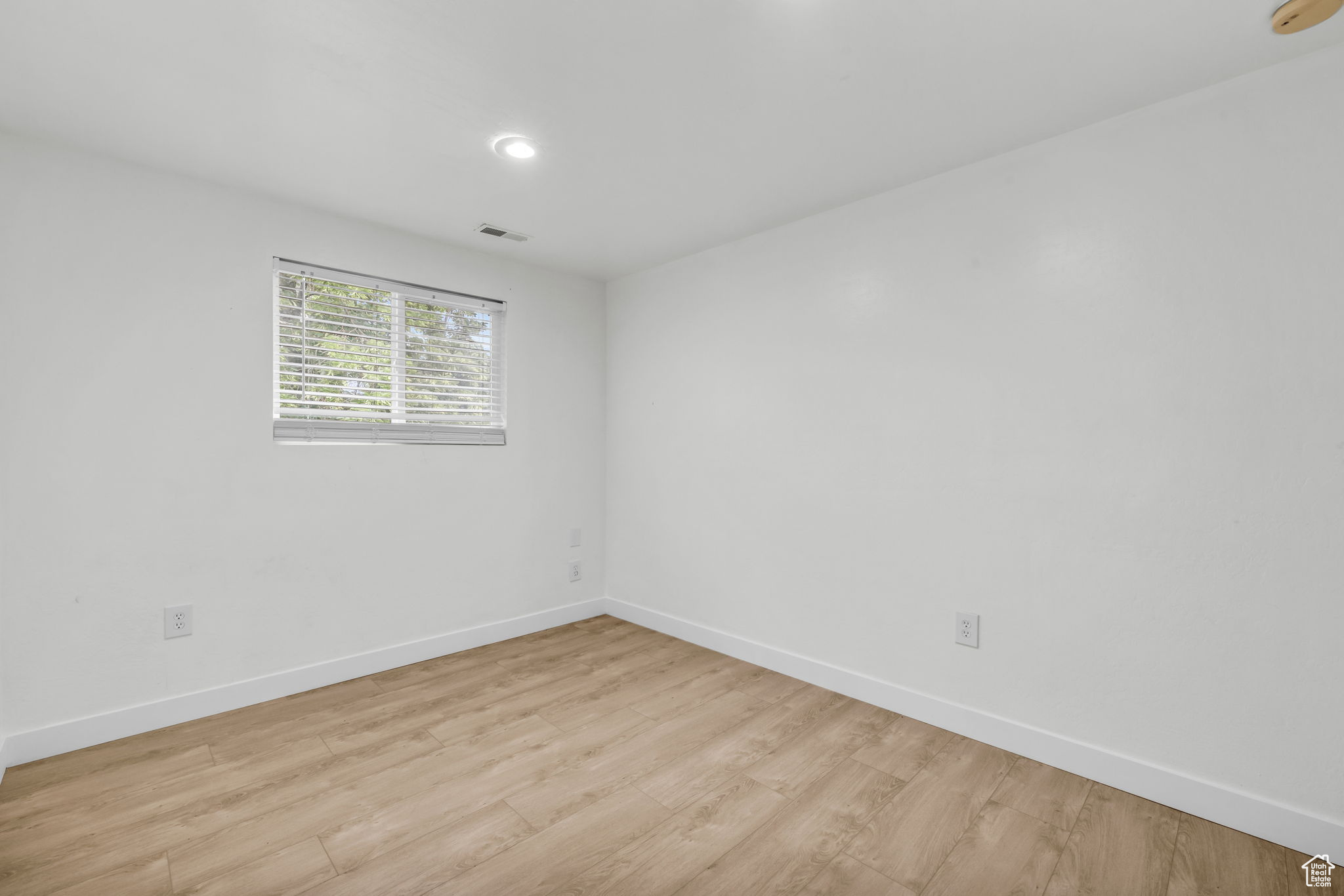 Spare room with light wood-type flooring