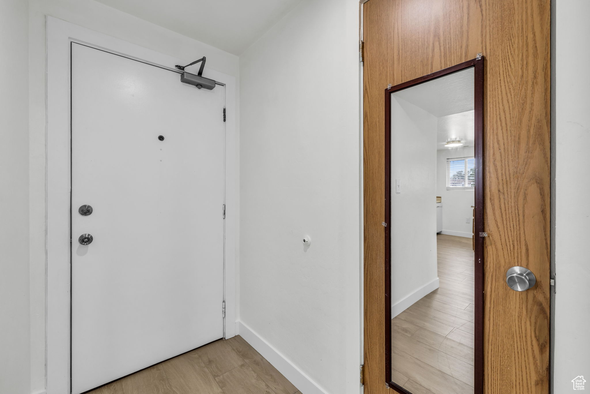 Doorway to outside featuring light hardwood / wood-style floors