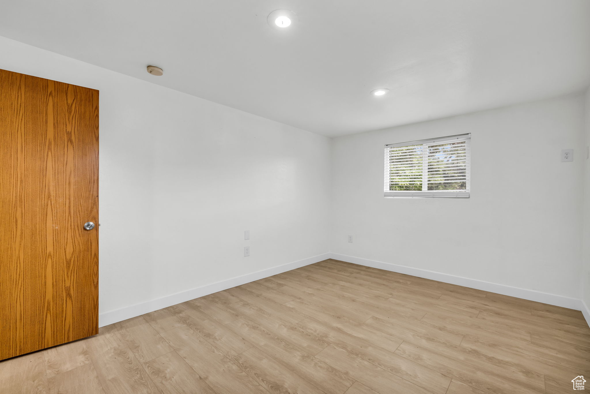 Empty room featuring light wood-type flooring