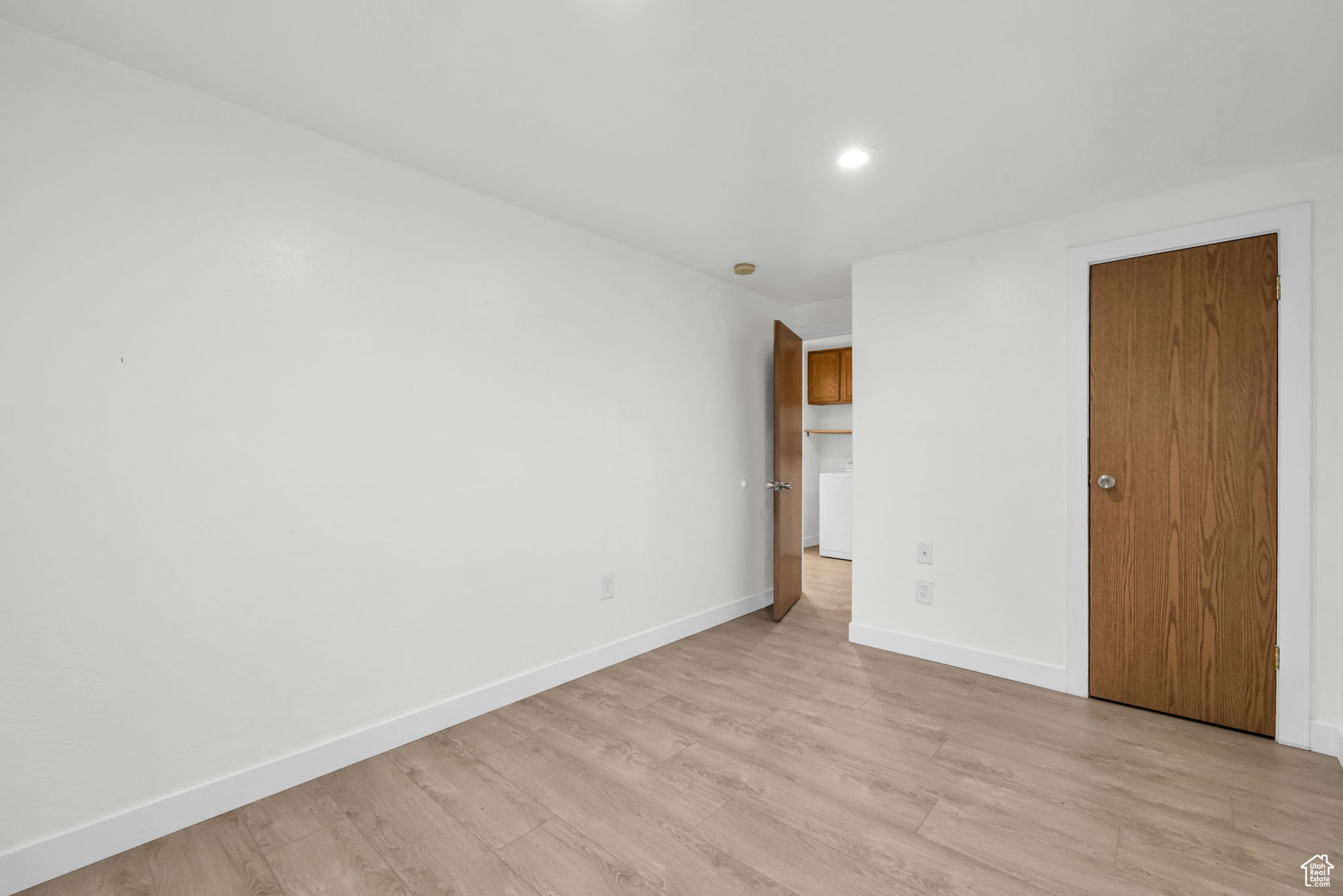 Unfurnished bedroom featuring a closet and light hardwood / wood-style flooring