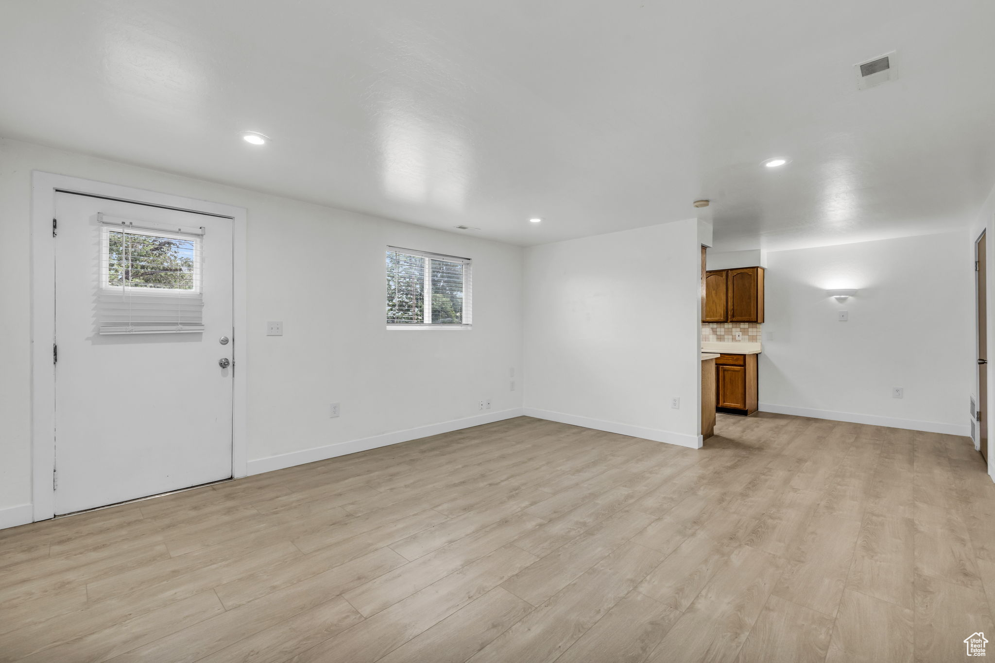 Unfurnished living room with light wood-type flooring