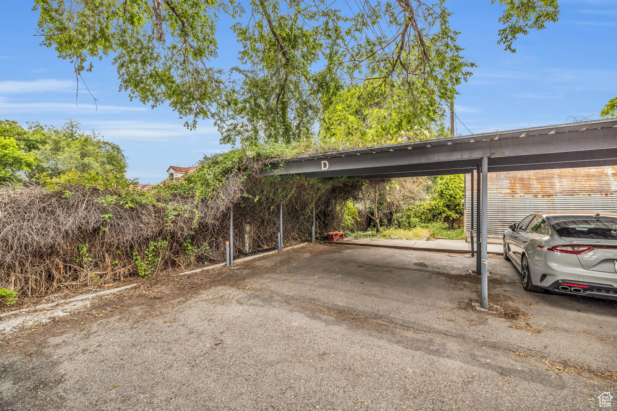 View of parking with a carport