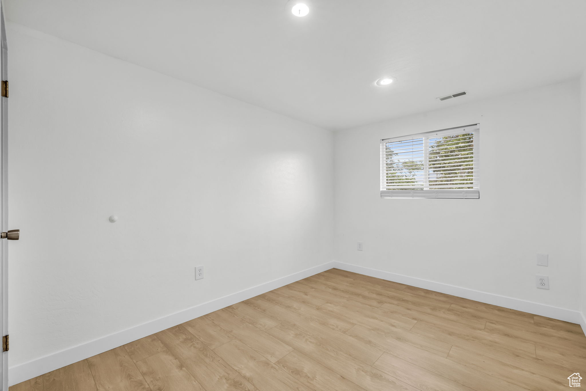 Unfurnished room with light hardwood / wood-style floors