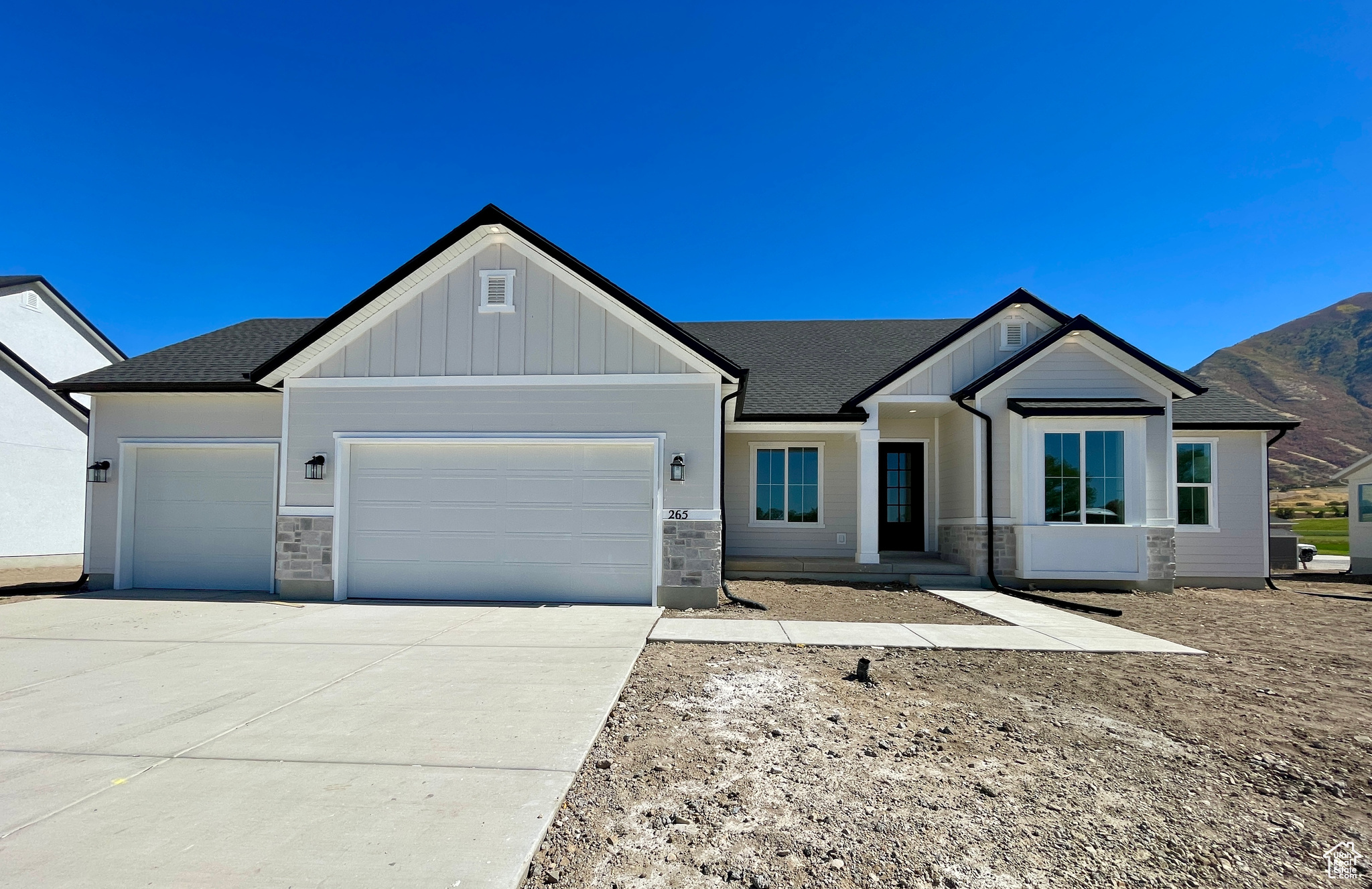 View of front of home featuring a garage and a mountain view