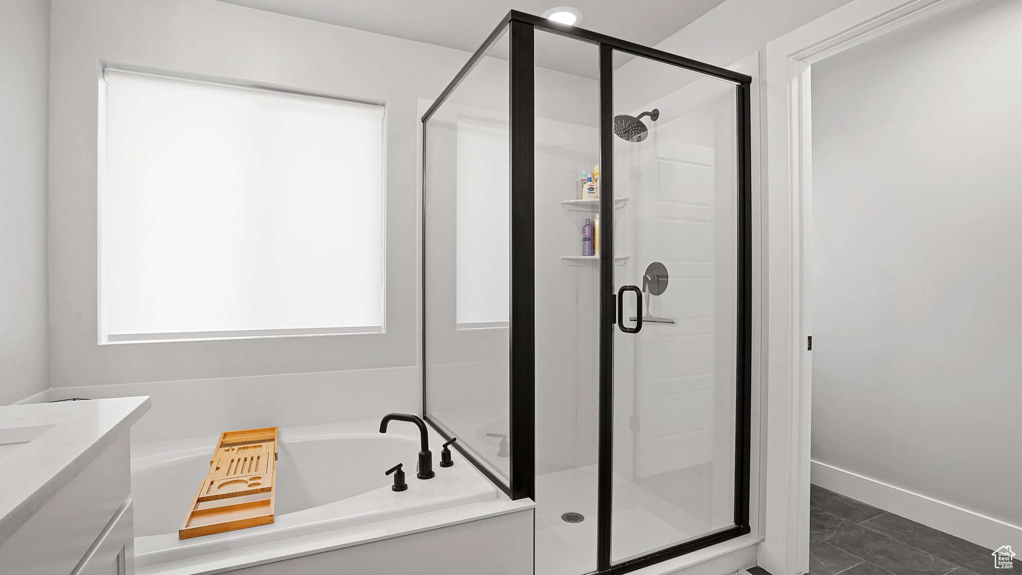 Bathroom with independent shower and bath, vanity, and tile floors