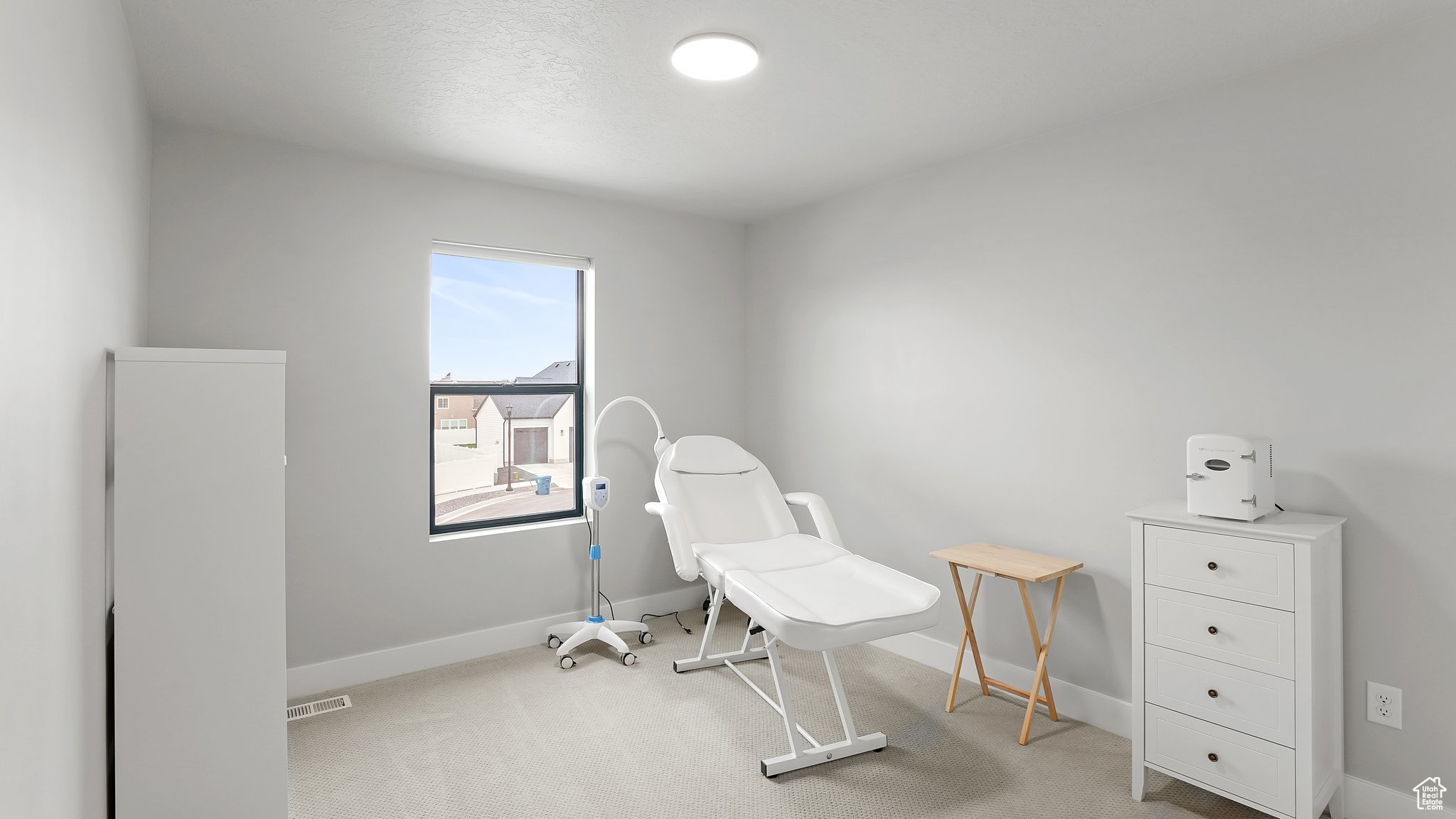 Home office with light colored carpet