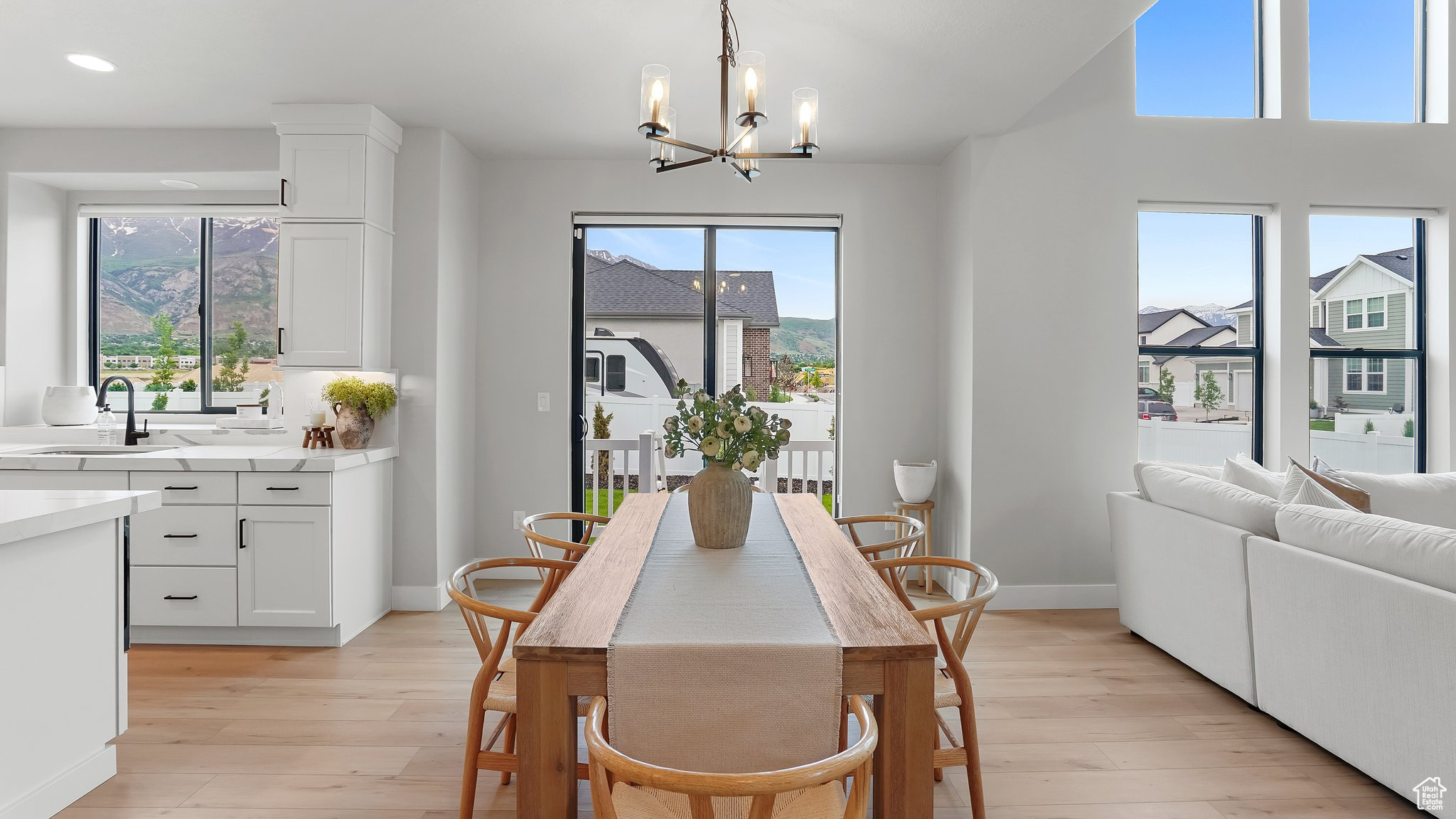 Dining space with sink, a healthy amount of sunlight, and light hardwood / wood-style flooring