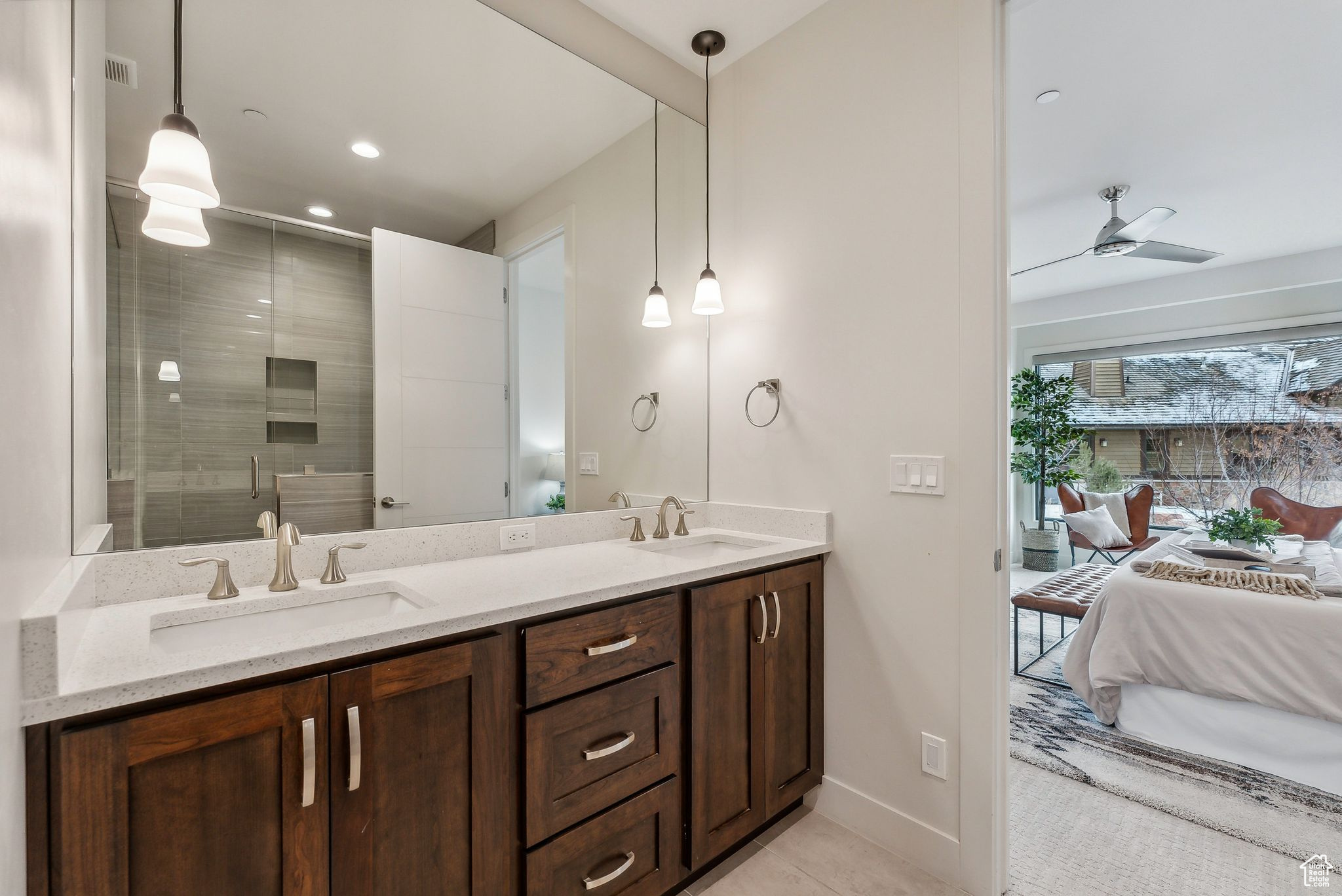 Bathroom with ceiling fan, tile patterned flooring, vanity, and an enclosed shower