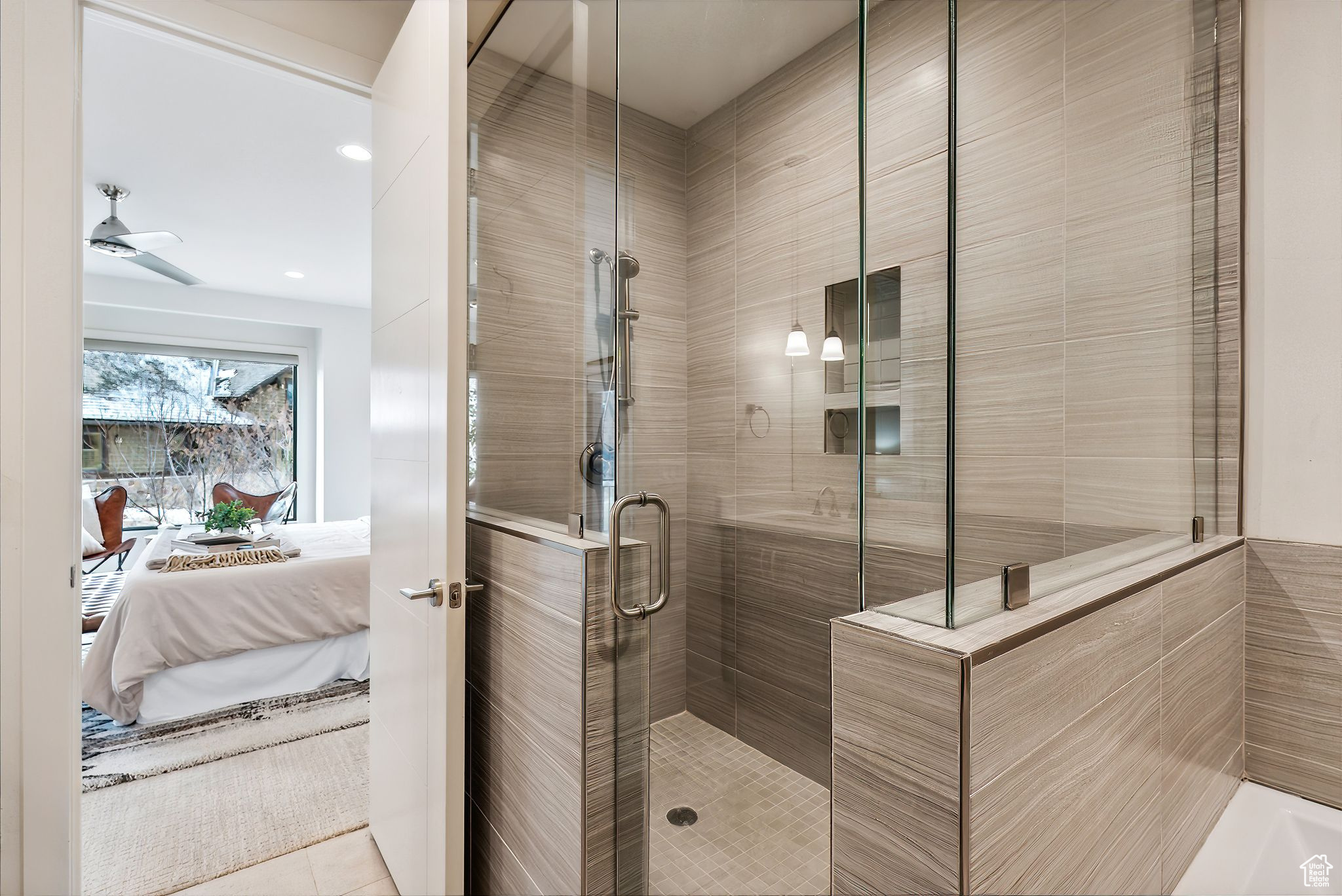 Bathroom featuring tile patterned flooring, ceiling fan, and a shower with shower door