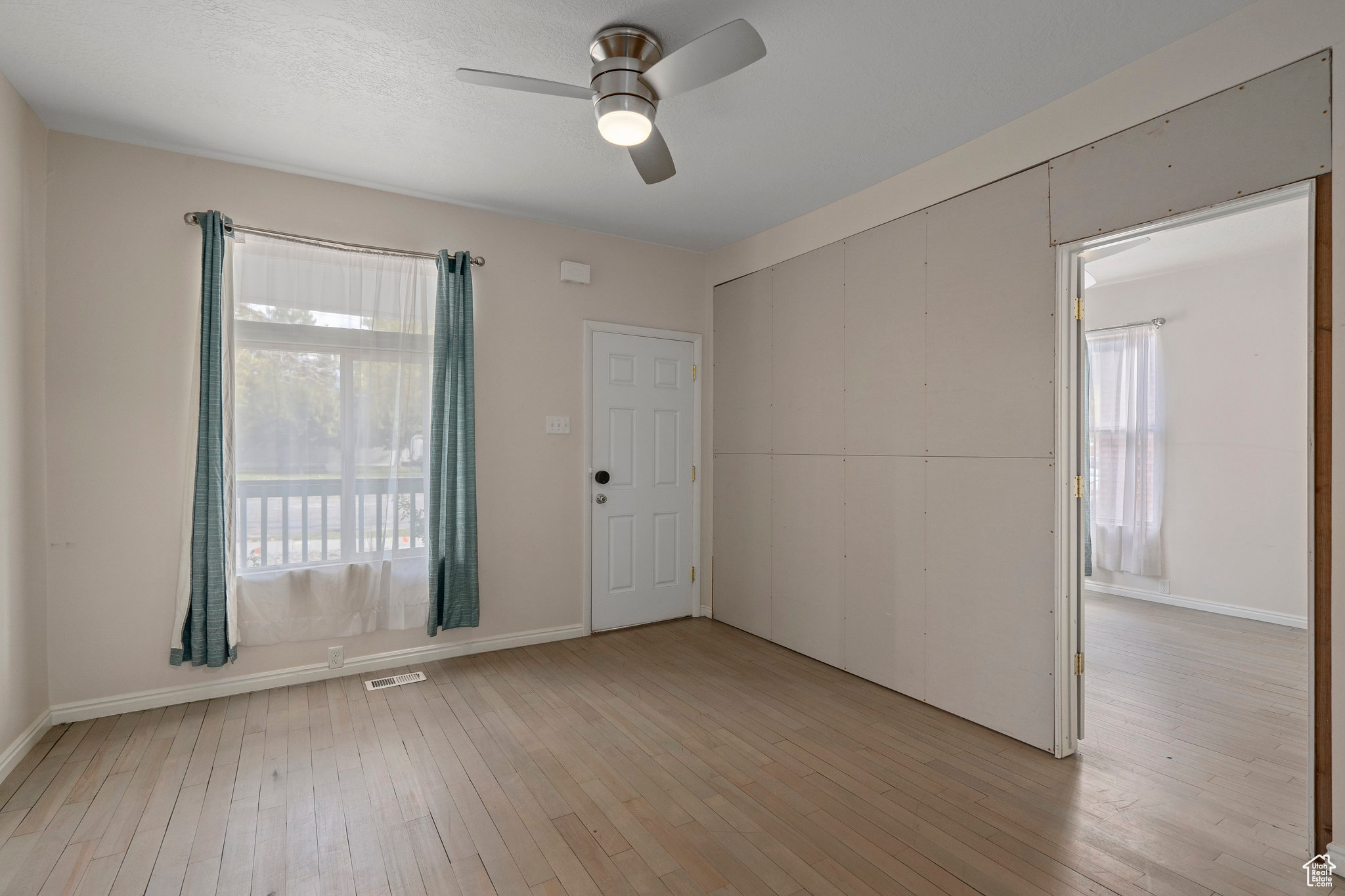 Spare room with light hardwood / wood-style flooring and ceiling fan