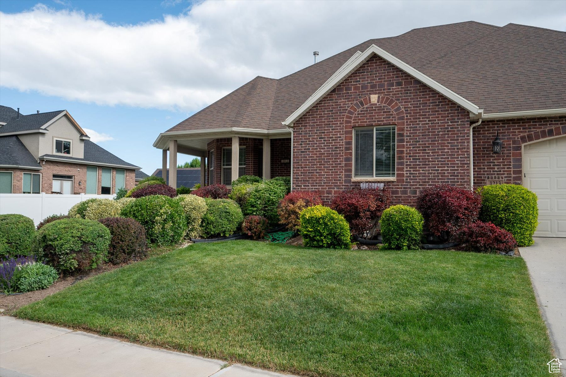 View of front of home featuring a garage and a front yard