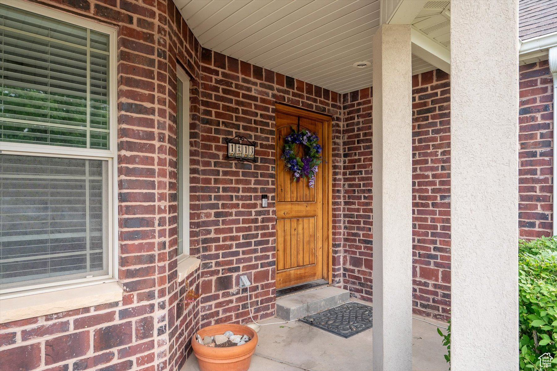 Doorway to property with covered porch