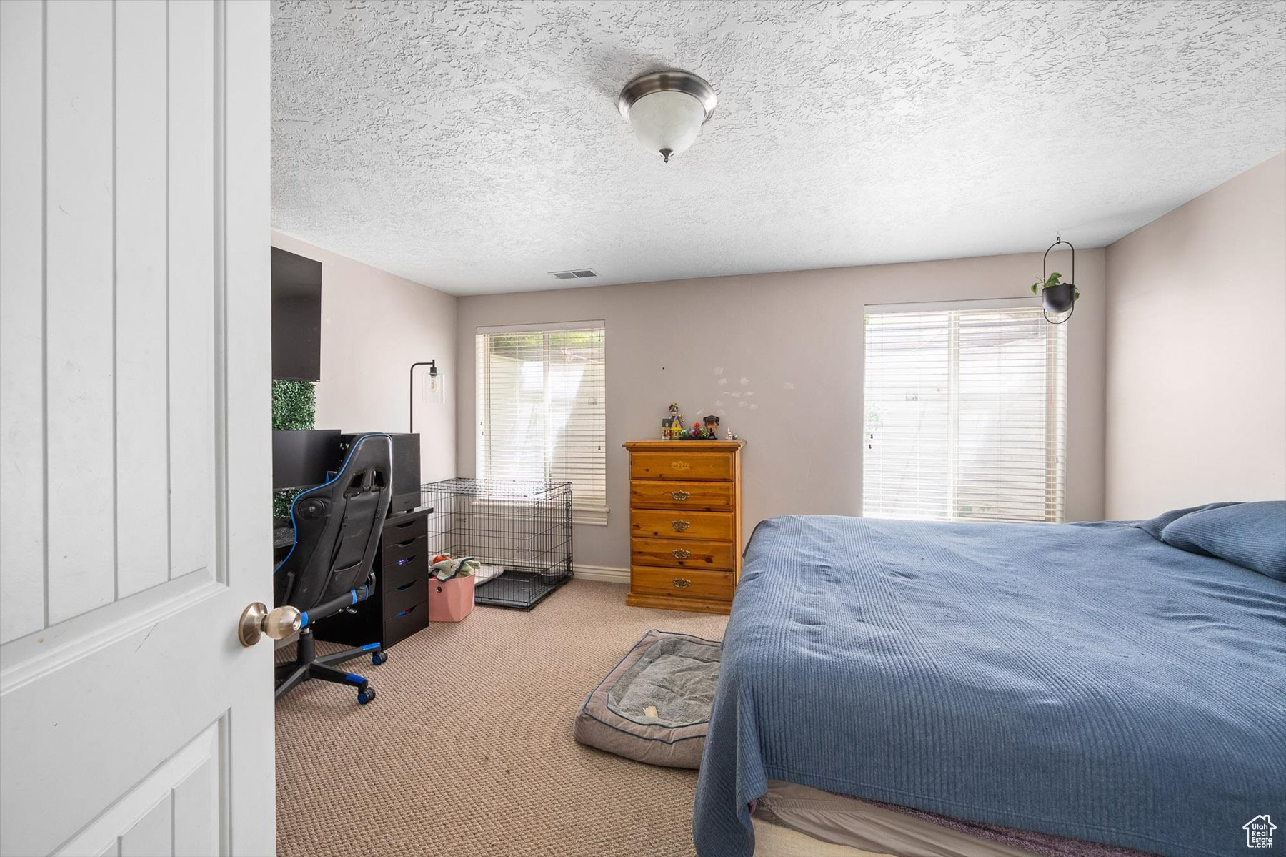 Carpeted bedroom featuring a textured ceiling