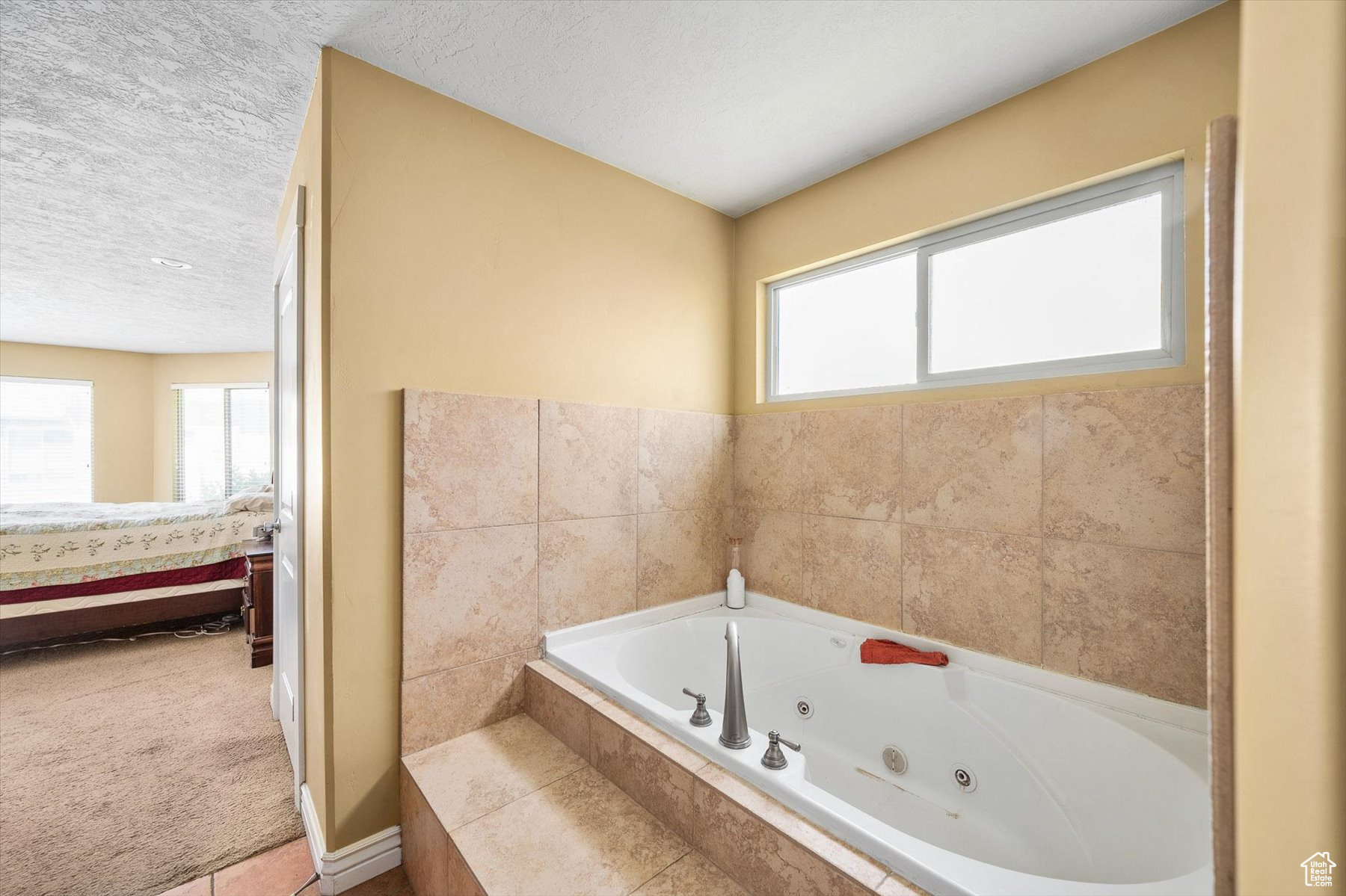 Bathroom featuring tile floors and a textured ceiling