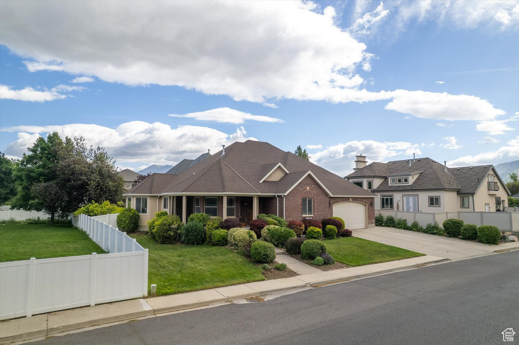 View of front facade featuring a garage and a front yard