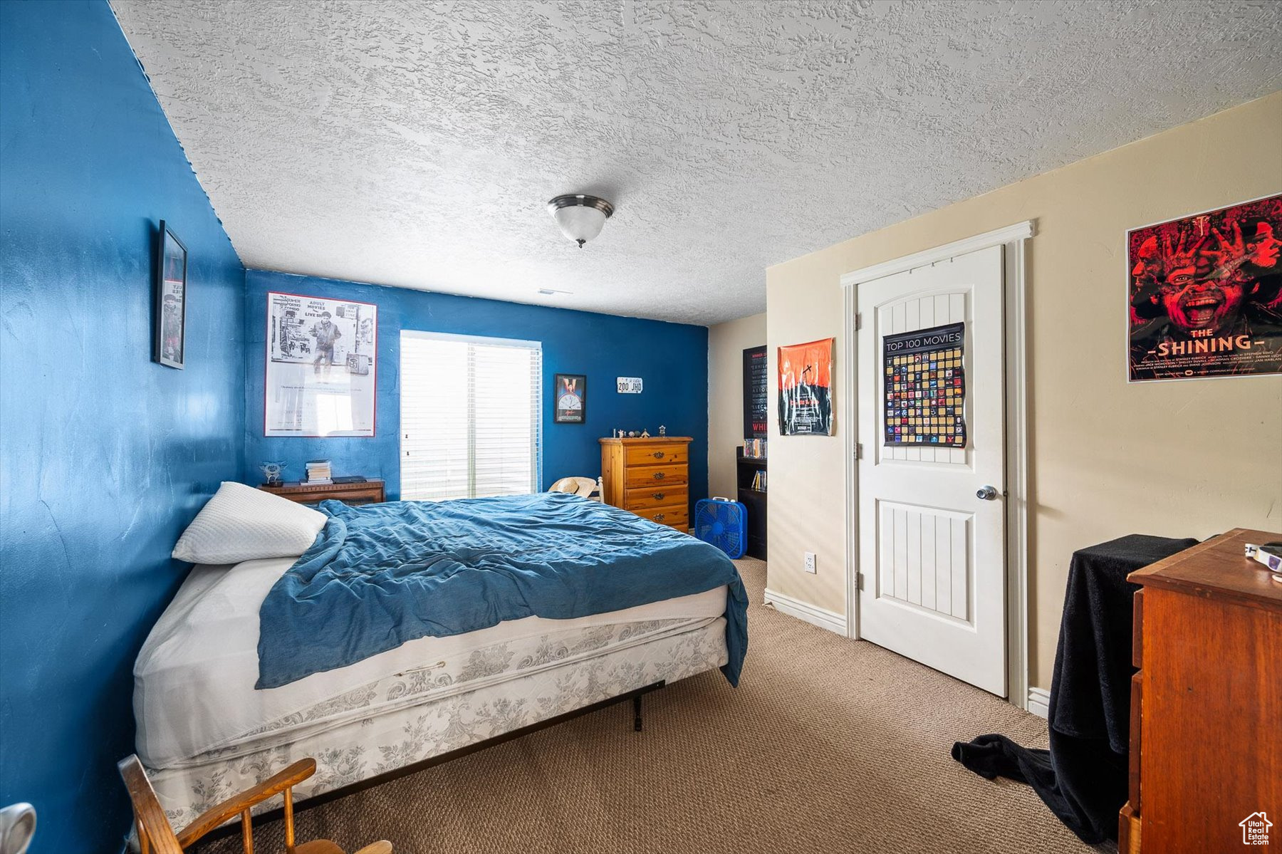 Carpeted bedroom featuring a textured ceiling