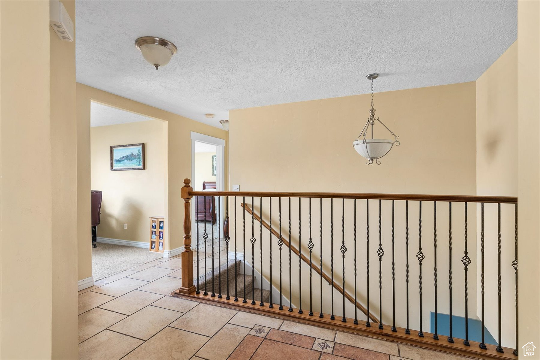 Corridor featuring tile flooring and a textured ceiling