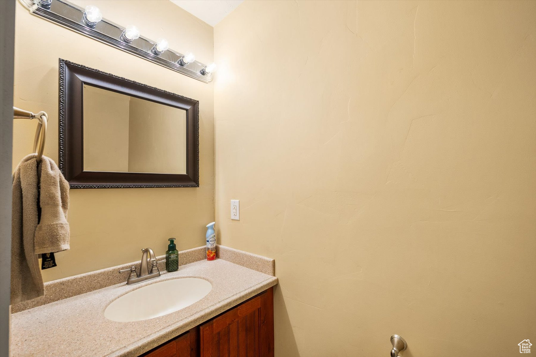 Half Bathroom with vanity off the garage and near the front entry way.