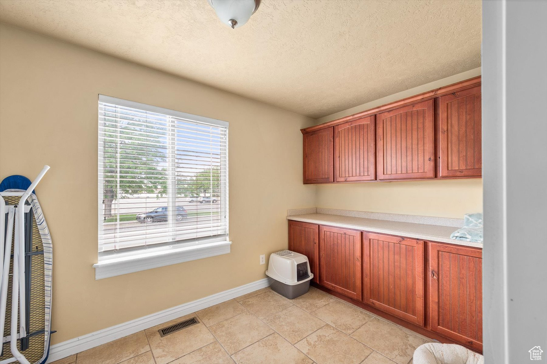 Laundry Room, What is with all of this Storage?!With light tile flooring and a textured ceiling