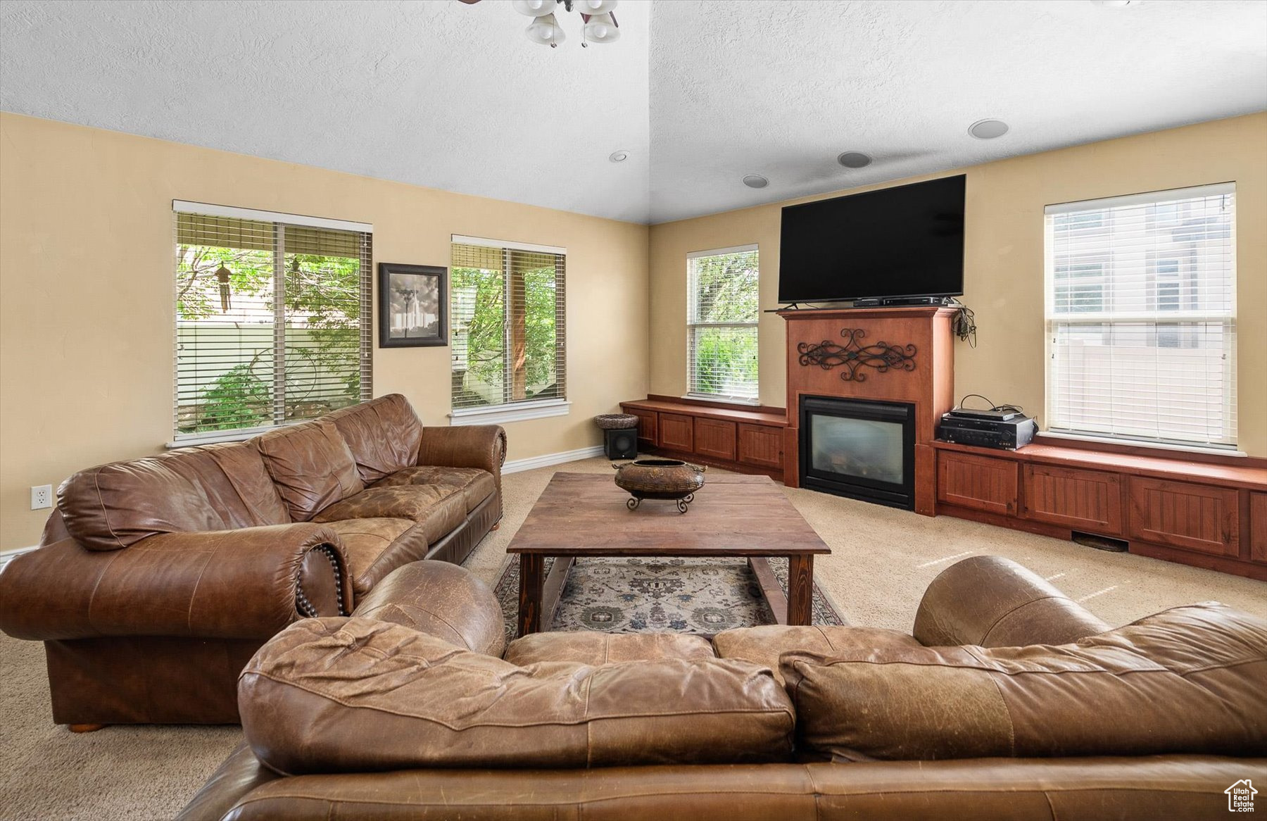 Living room featuring light carpet and a textured ceiling