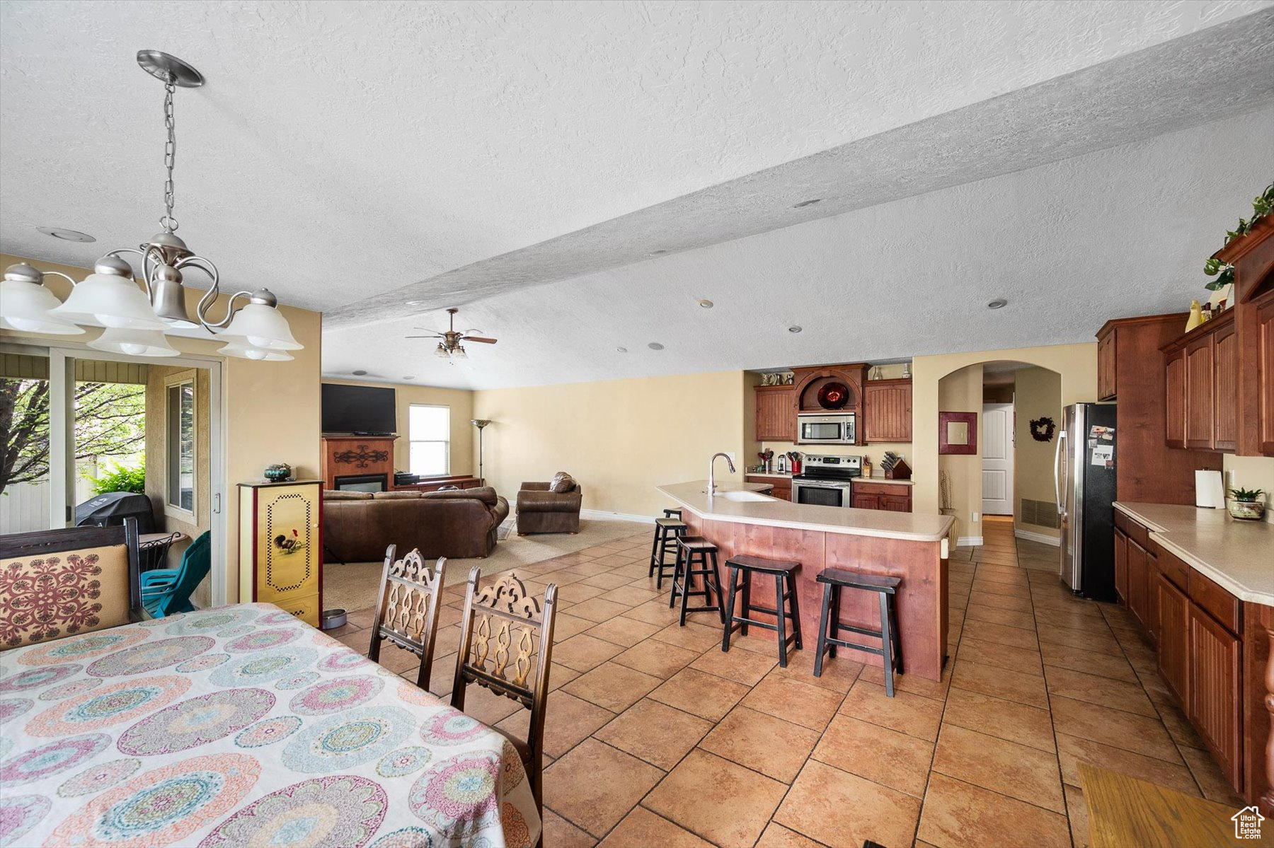 Dining space featuring plenty of natural light, light tile flooring, and a textured ceiling