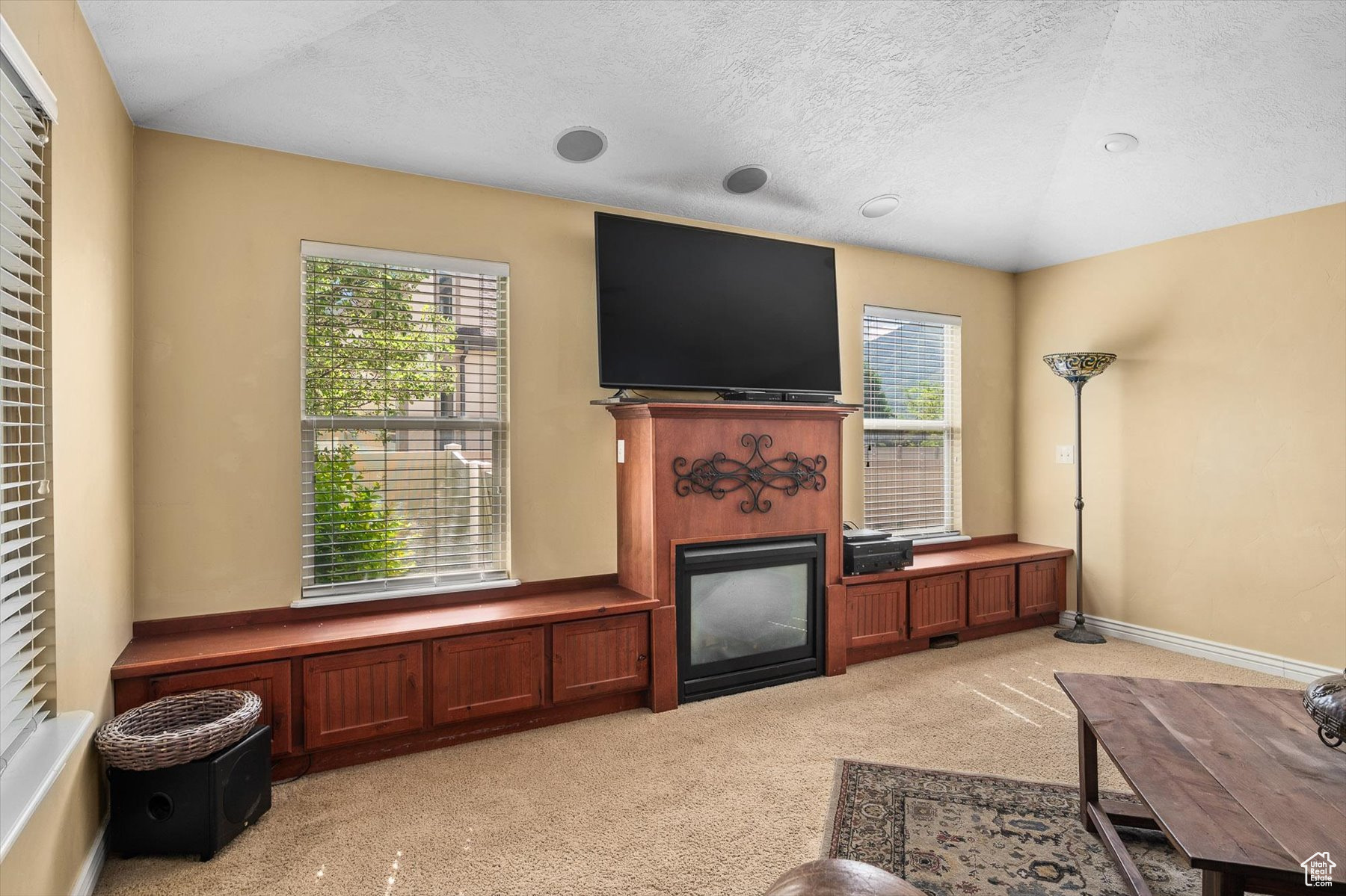 Carpeted living room featuring a textured ceiling