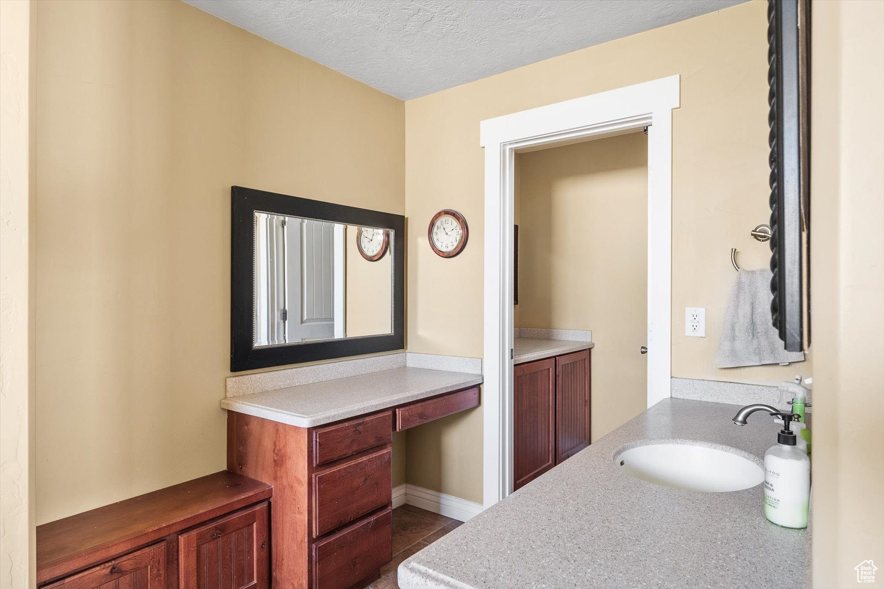 Bathroom with a textured ceiling and vanity dressing table and separate toilet