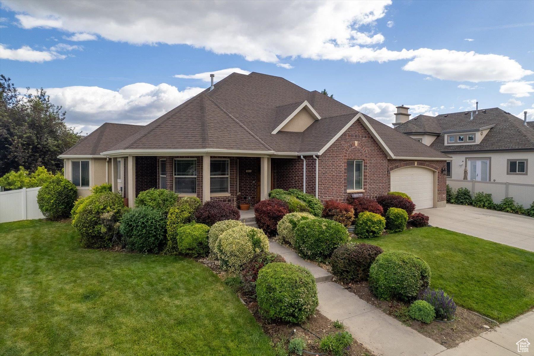 View of front of property featuring a front lawn and a garage