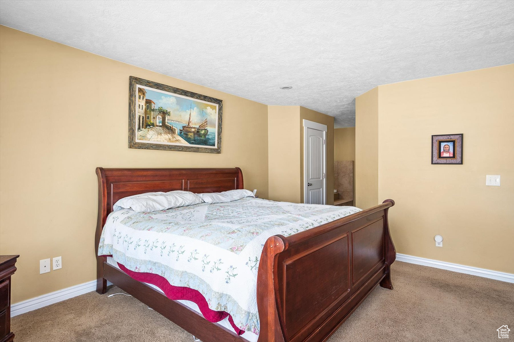 Bedroom with carpet flooring and a textured ceiling