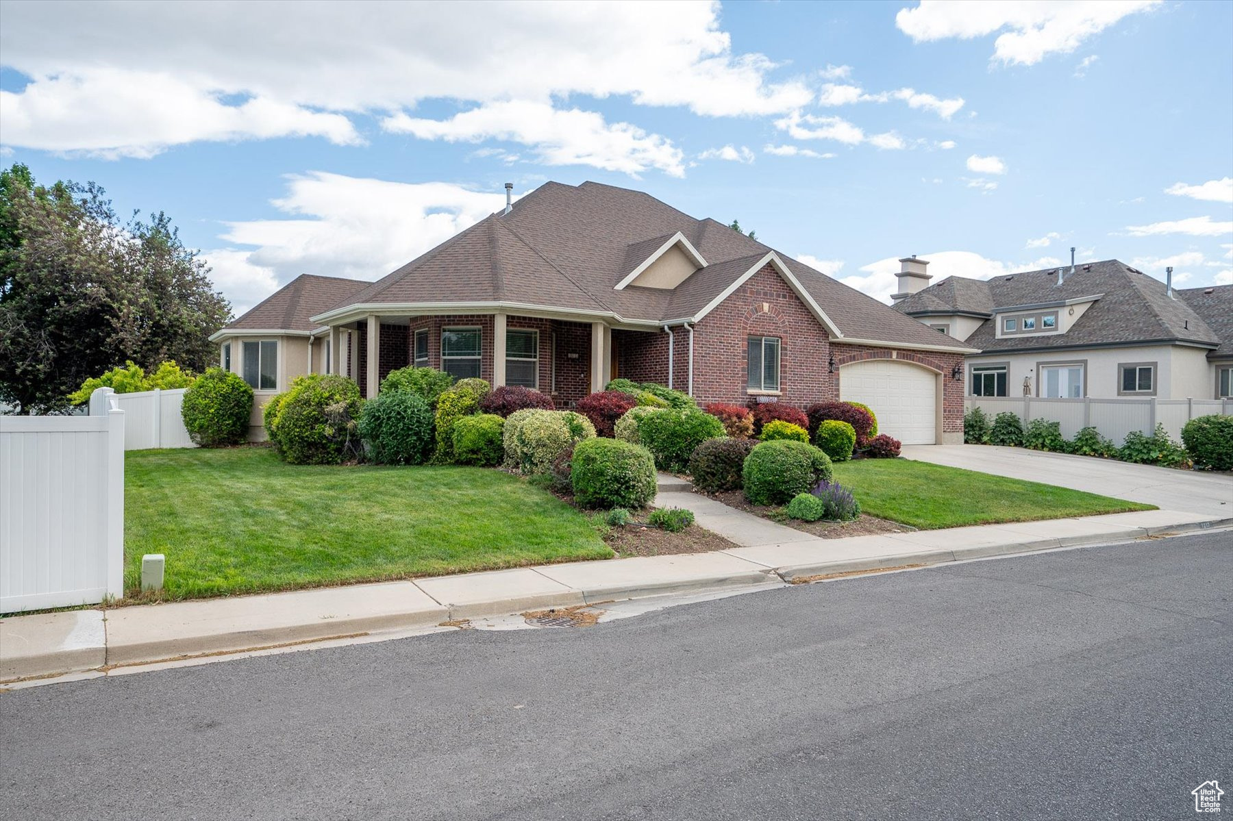 View of front of home featuring a garage and a front lawn