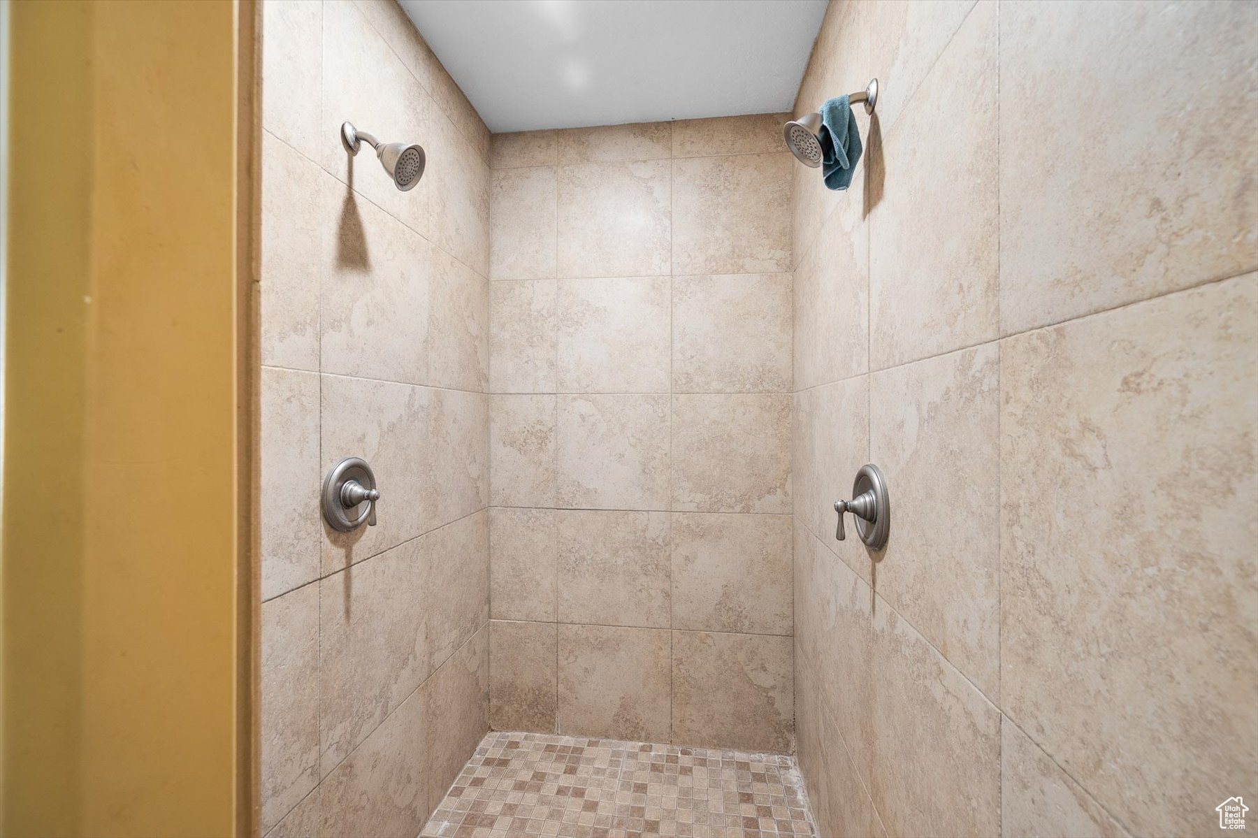 Tiled shower with two shower heads so no one needs to have a cold back!