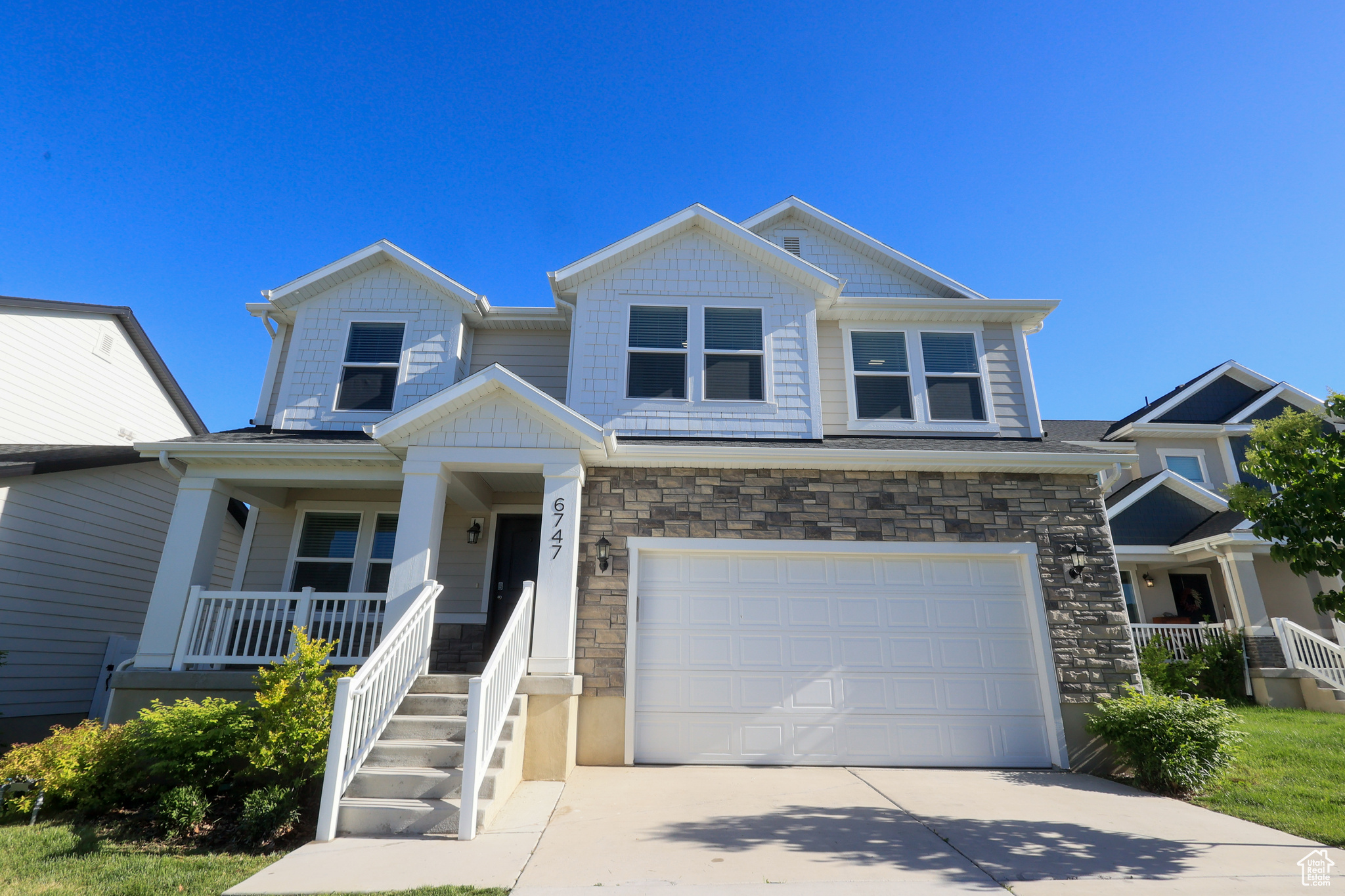 Craftsman inspired home featuring a garage and covered porch