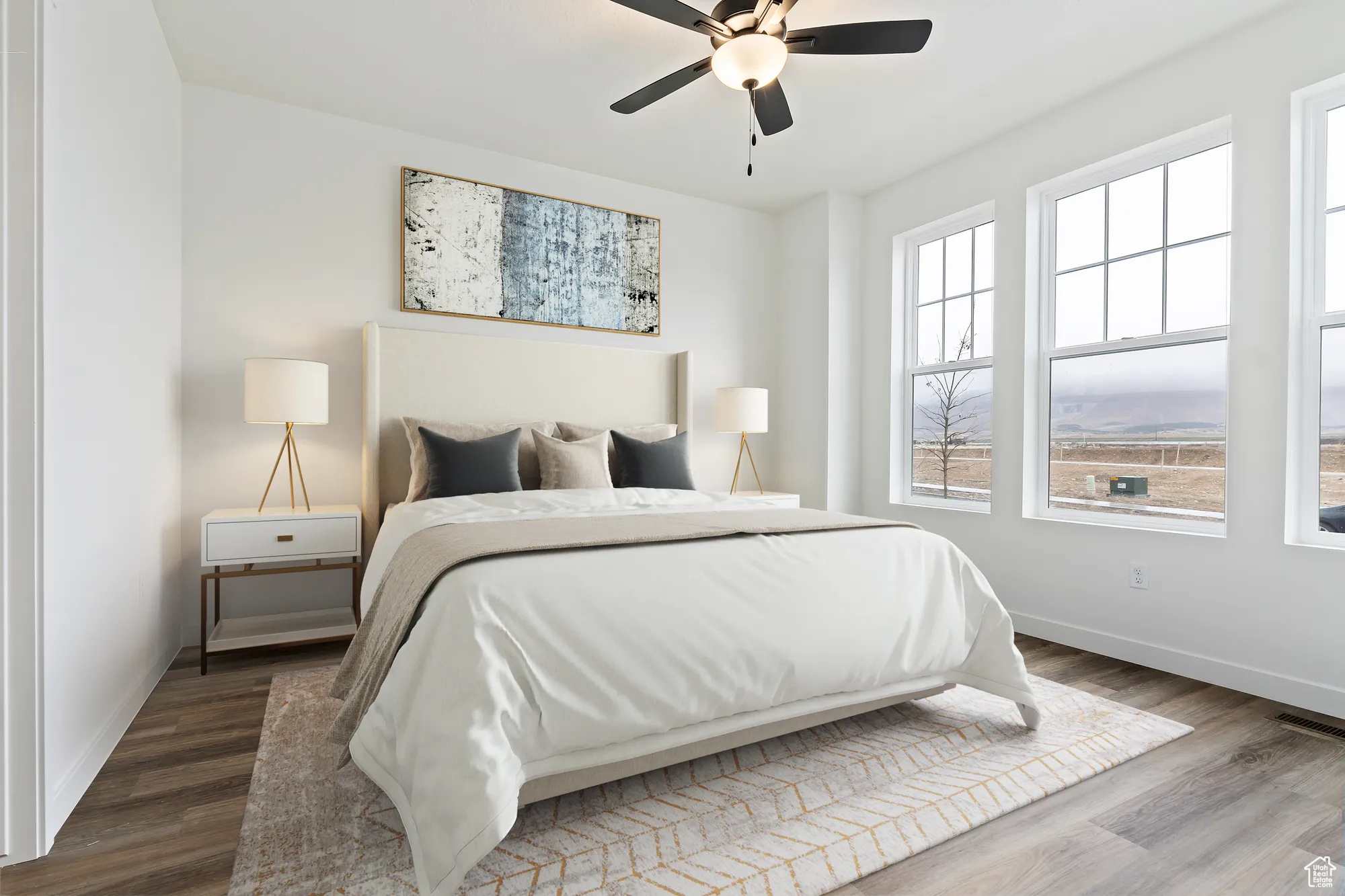 Bedroom featuring dark wood-type flooring, ceiling fan, and multiple windows