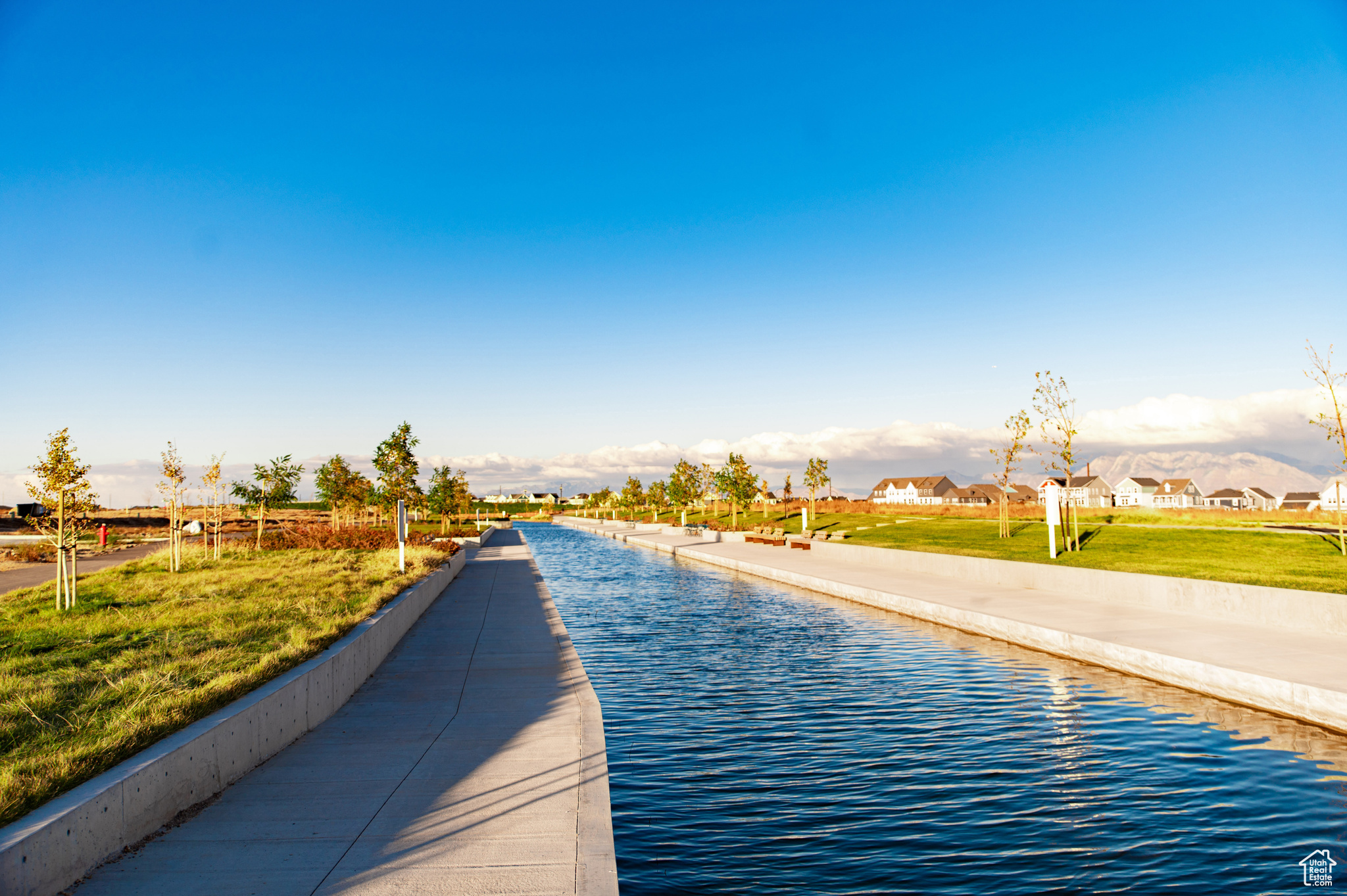 View of pool featuring a lawn and a water view