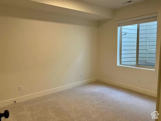 Unfurnished room with carpet floors