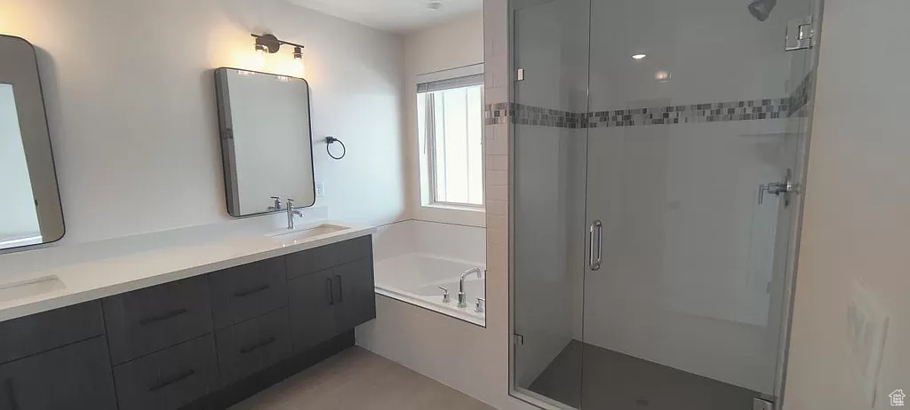 Bathroom with separate shower and tub and dual bowl vanity