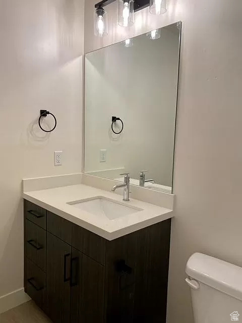 Bathroom with toilet and large vanity