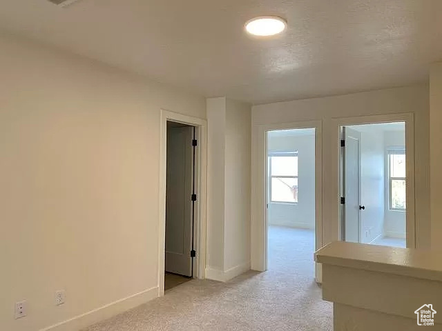 Hallway featuring carpet