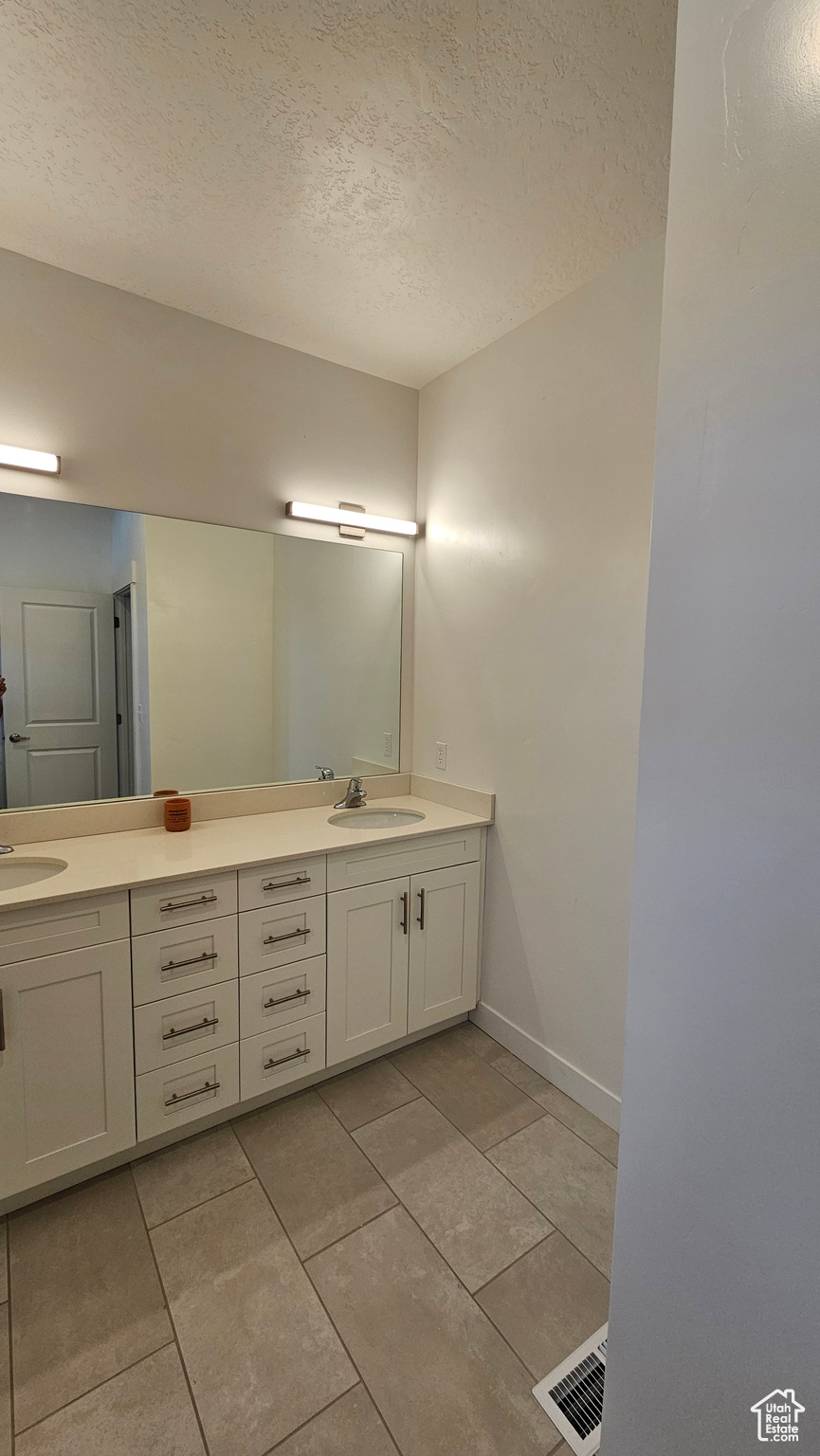 Bathroom featuring oversized vanity and double sink