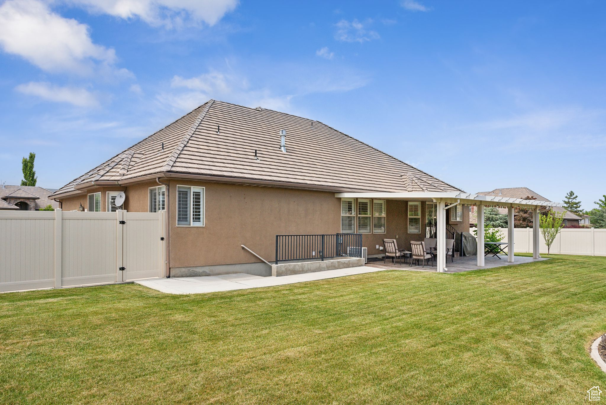 Back of house with a patio area and a yard