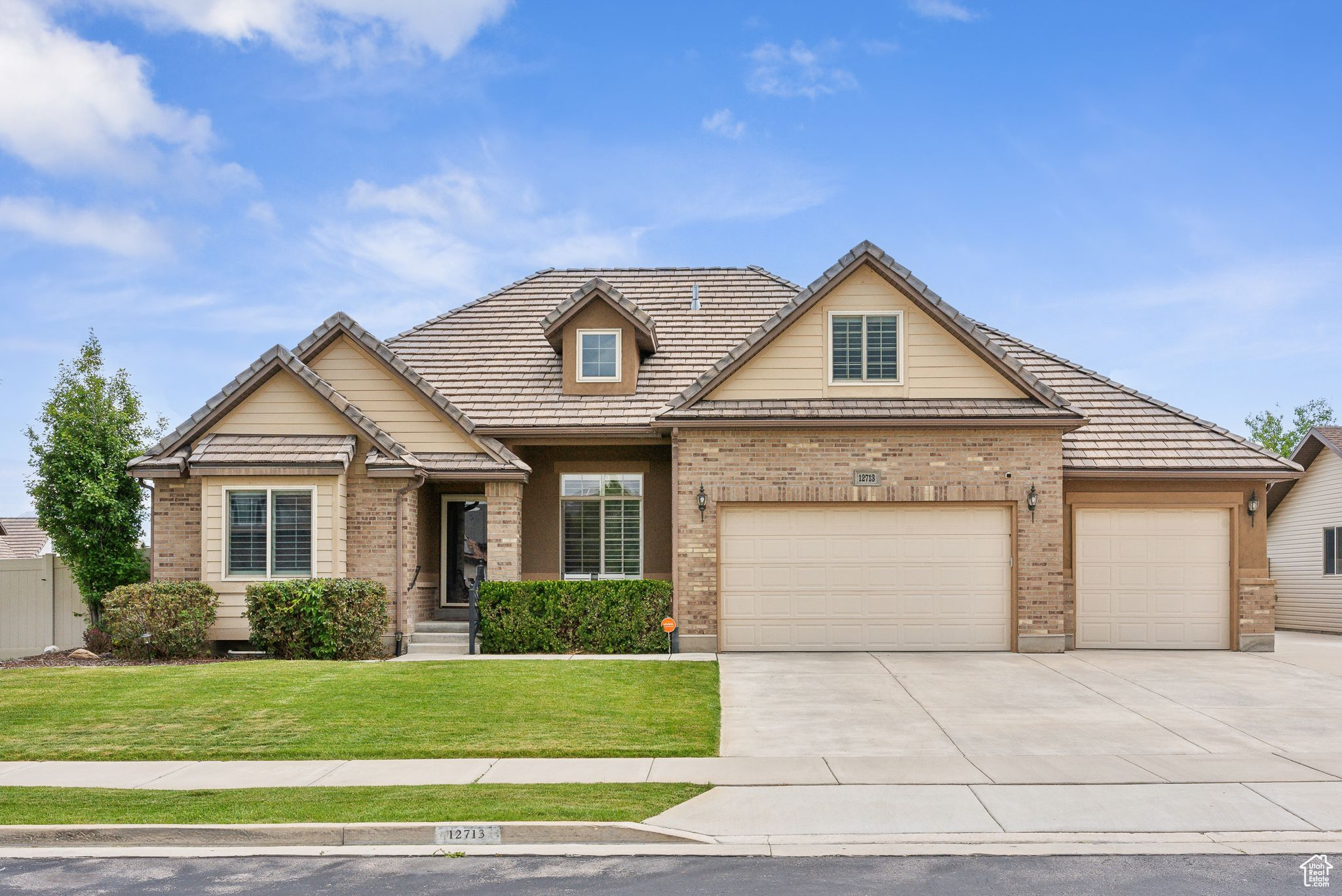 View of front of house featuring a garage and a front yard