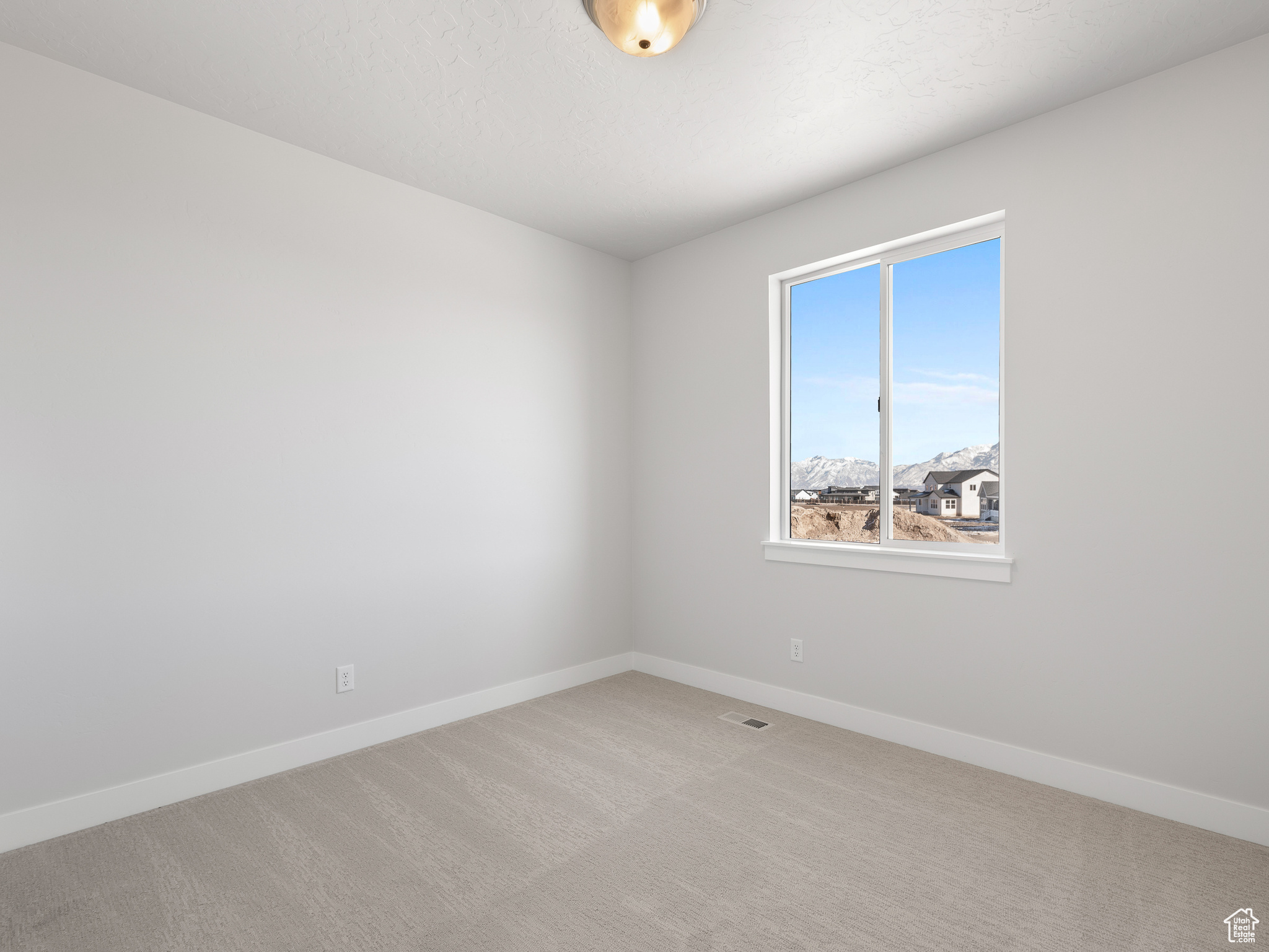 View of carpeted empty room. This is a picture of Helena model home. Not the interior of actual home.