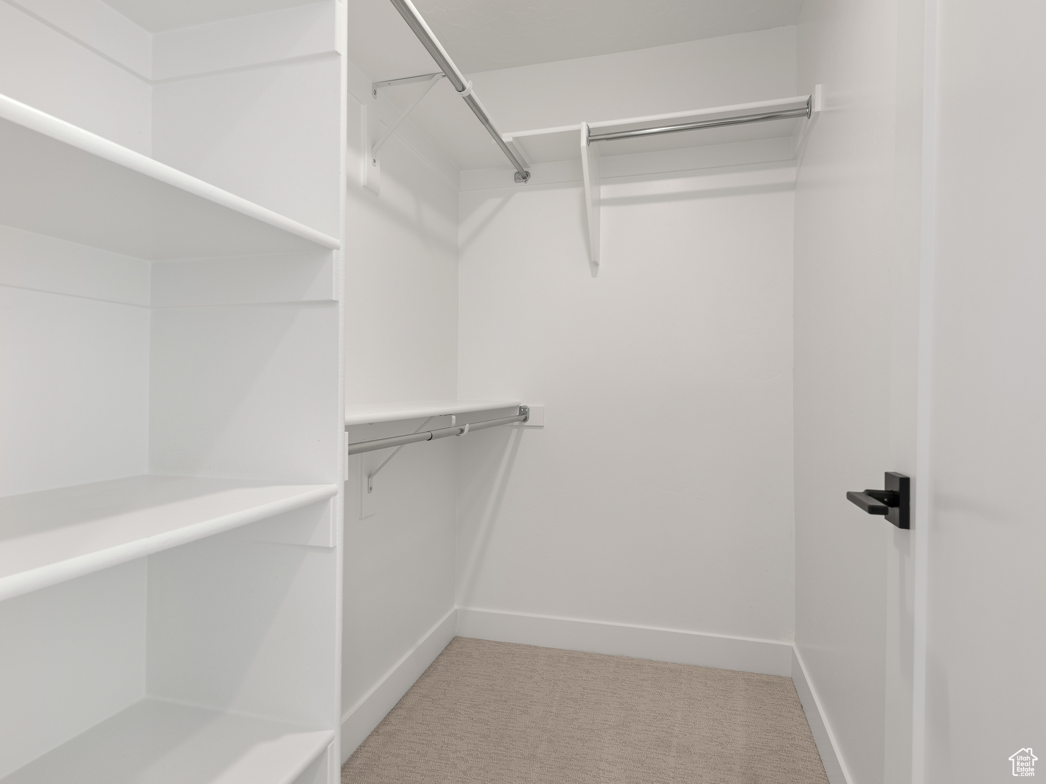 Walk in closet featuring carpet floors. This is a picture of Helena model home. Not the interior of actual home.